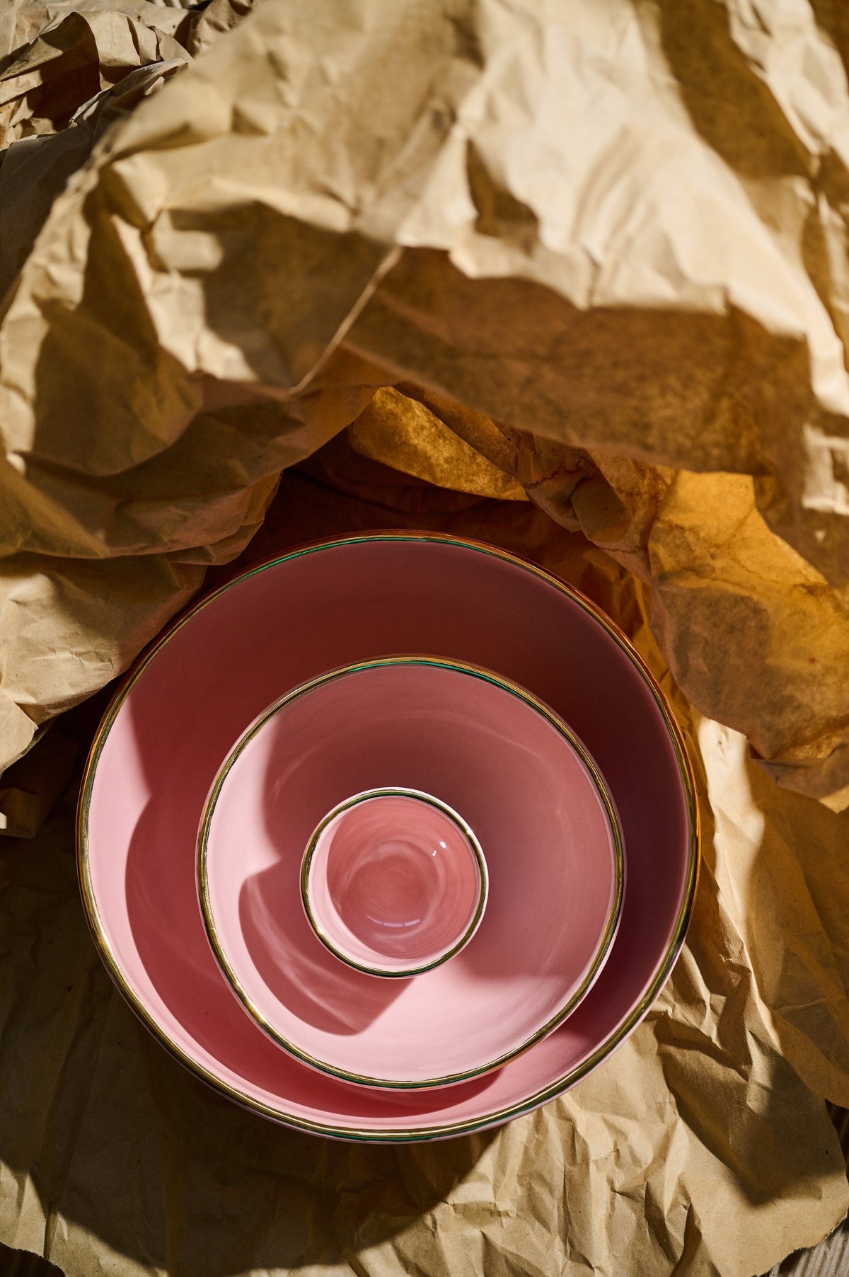 Handmade porcelain pink salad bowl with gold rim and shiny glazed interior