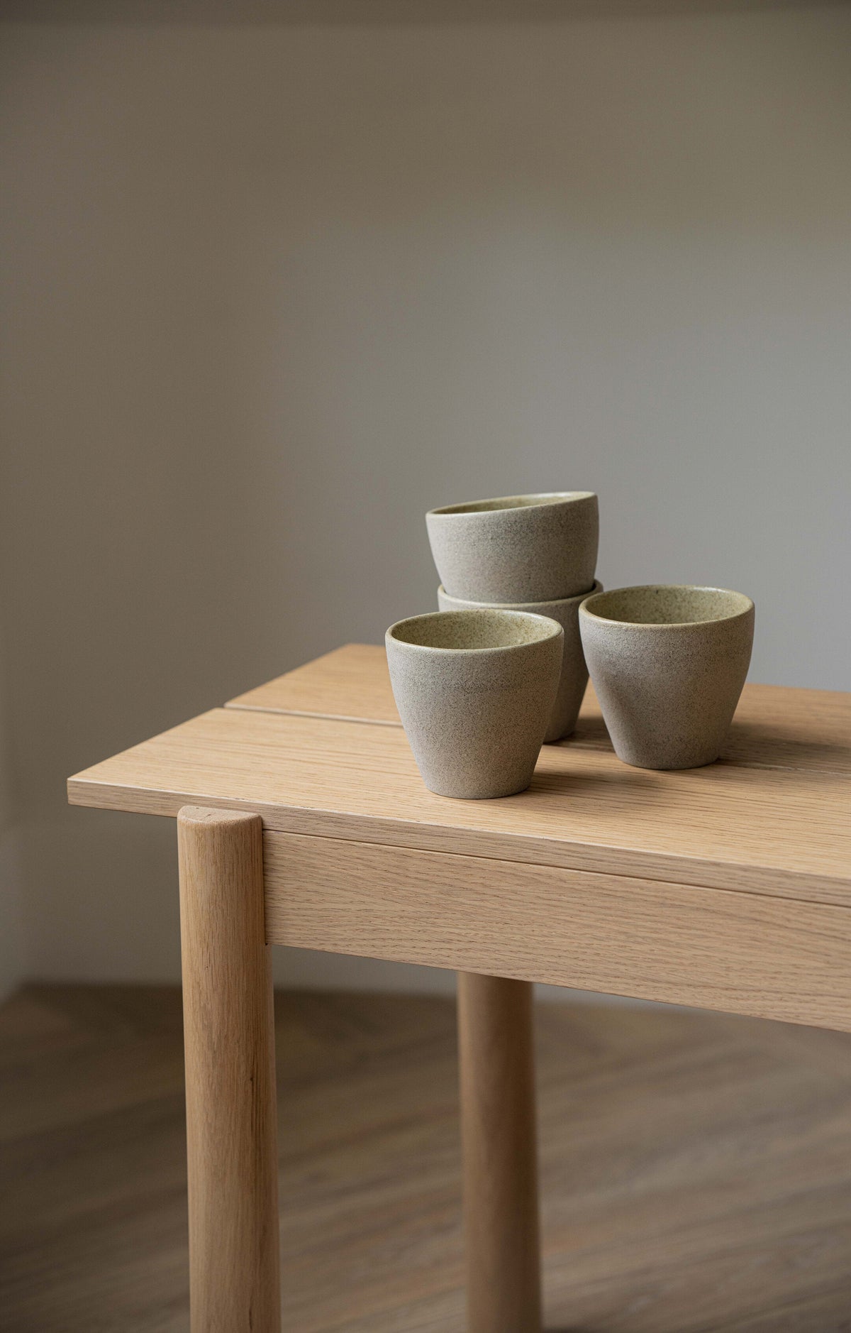 Handmade stoneware coffee mug with concrete-like texture and glossy interior glaze