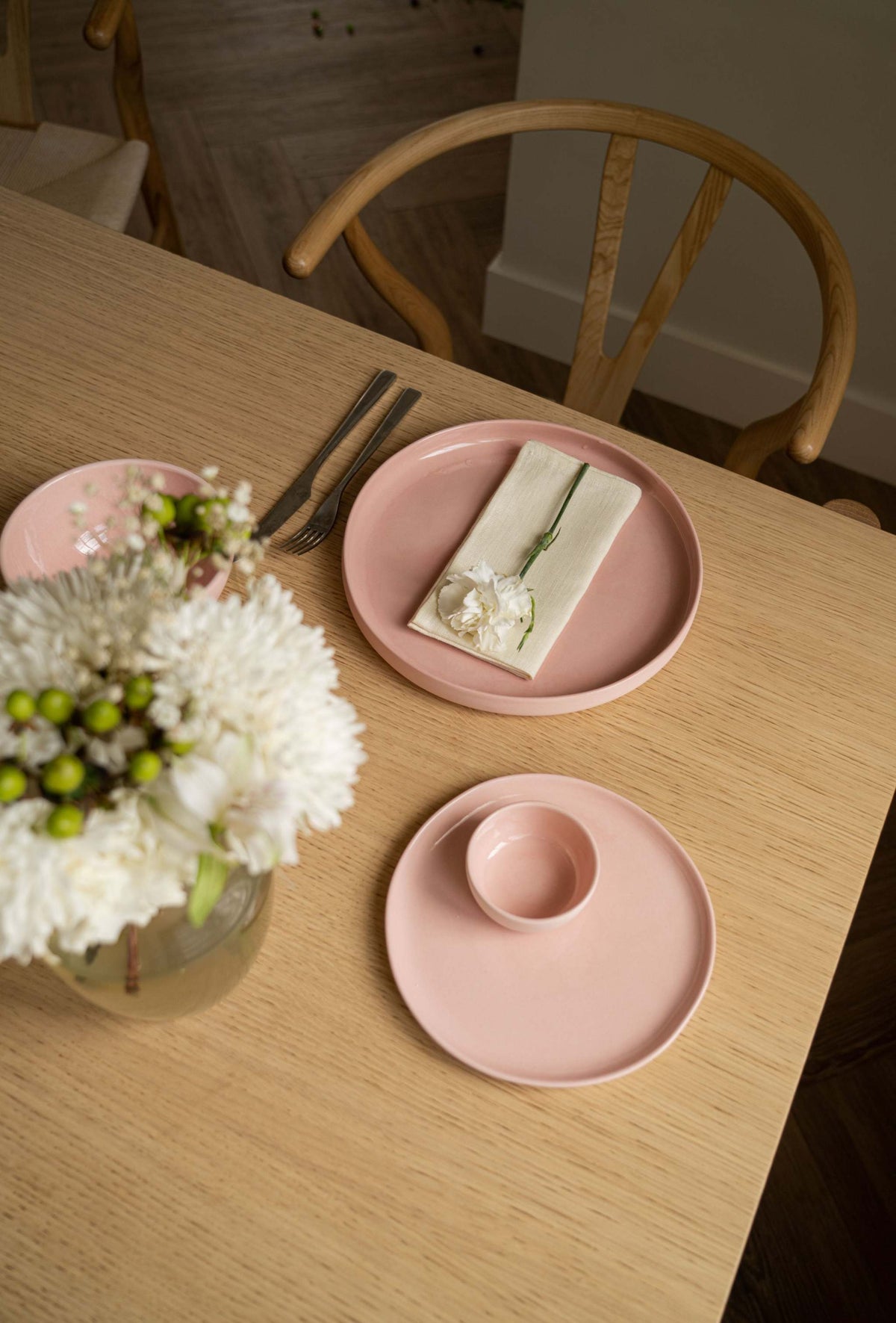 Handmade porcelain coffee cup in powder pink with shiny glaze, polished exterior, and safe for dishwasher and microwave use.