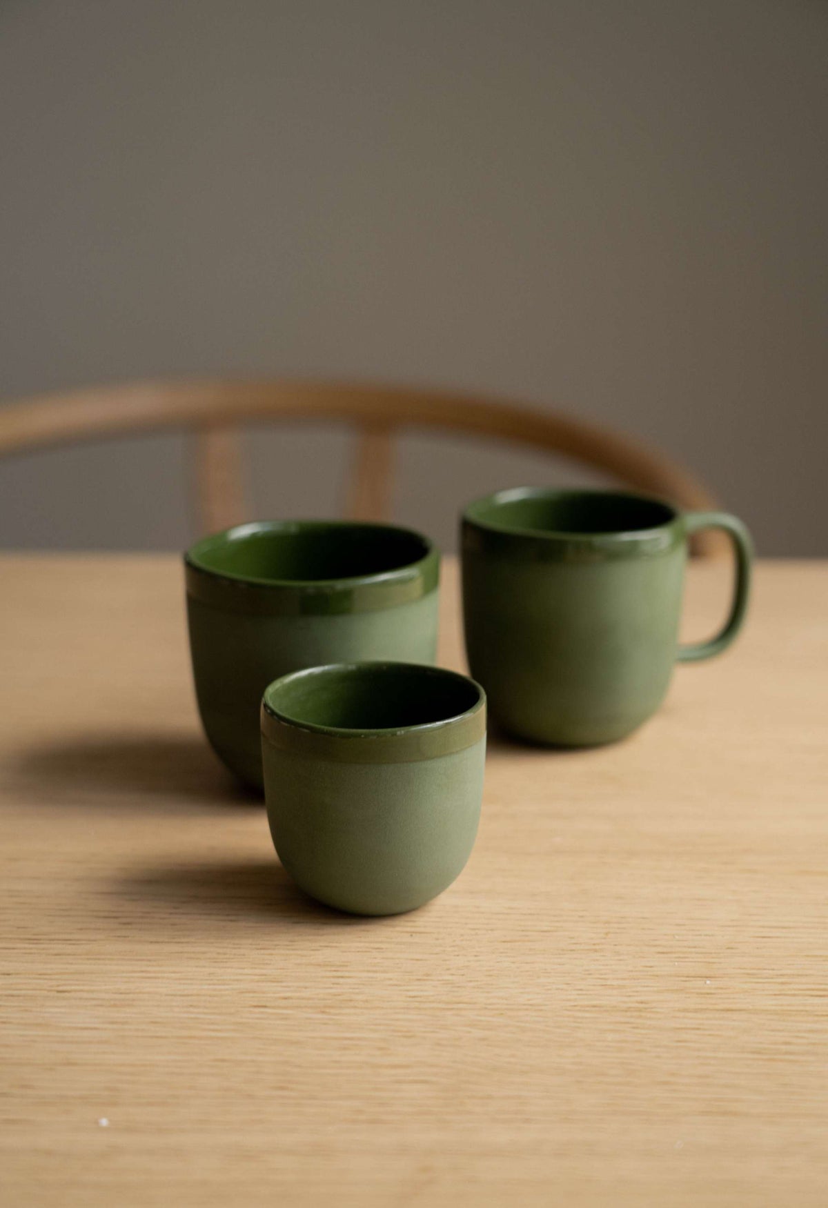 Handmade green porcelain coffee cup with glossy glaze and smooth finish