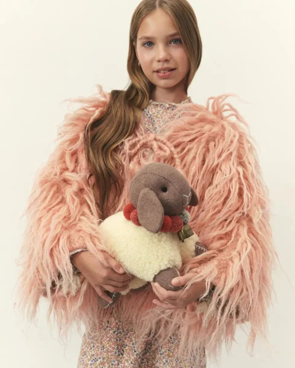 Wool Lamb Toy with a cream curly wool body, taupe cotton face and legs, dark eyes, and red neck accents.