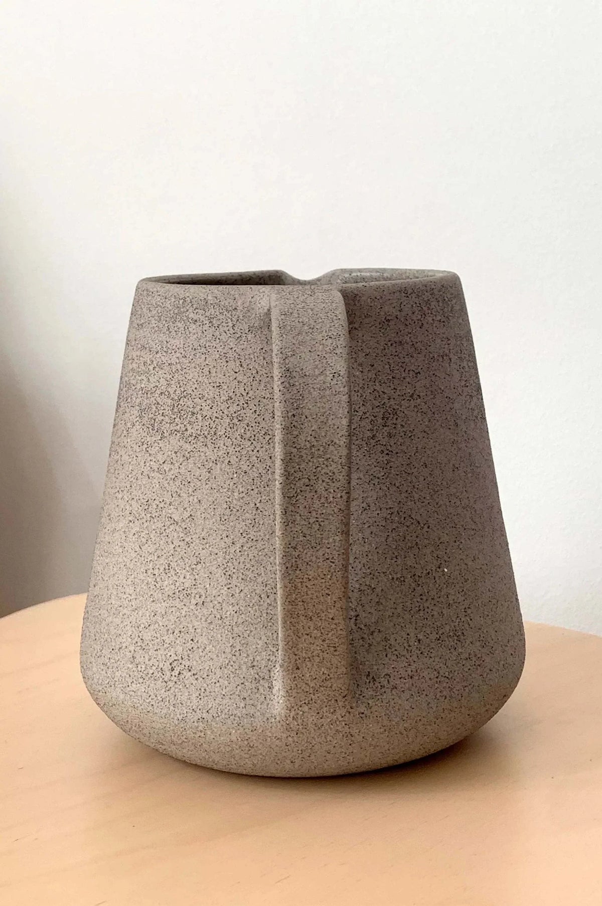 Handmade Stoneware Pitcher in speckled concrete-gray stoneware, with a matte finish and sculptural angular handle.