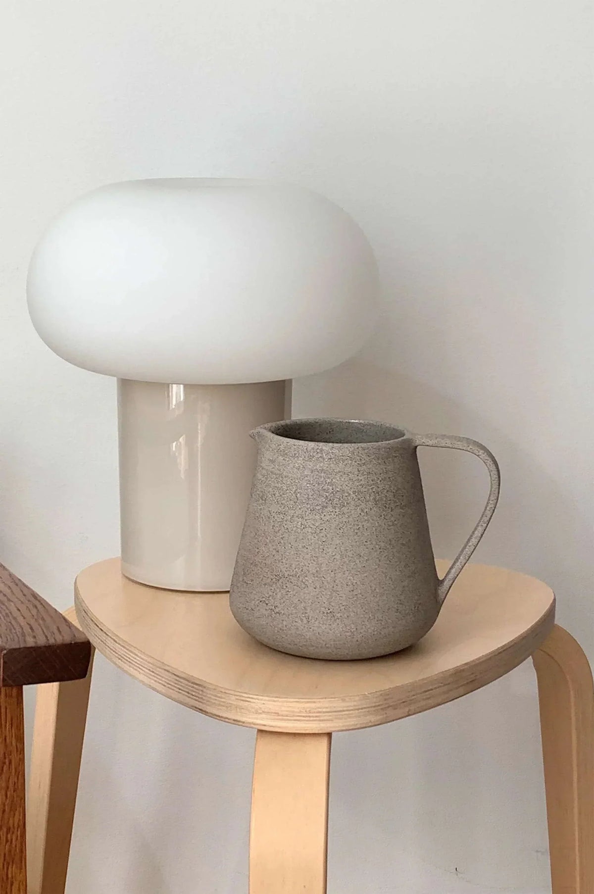 Handmade Stoneware Pitcher in speckled gray with a matte textured finish, rounded body, and curved handle.