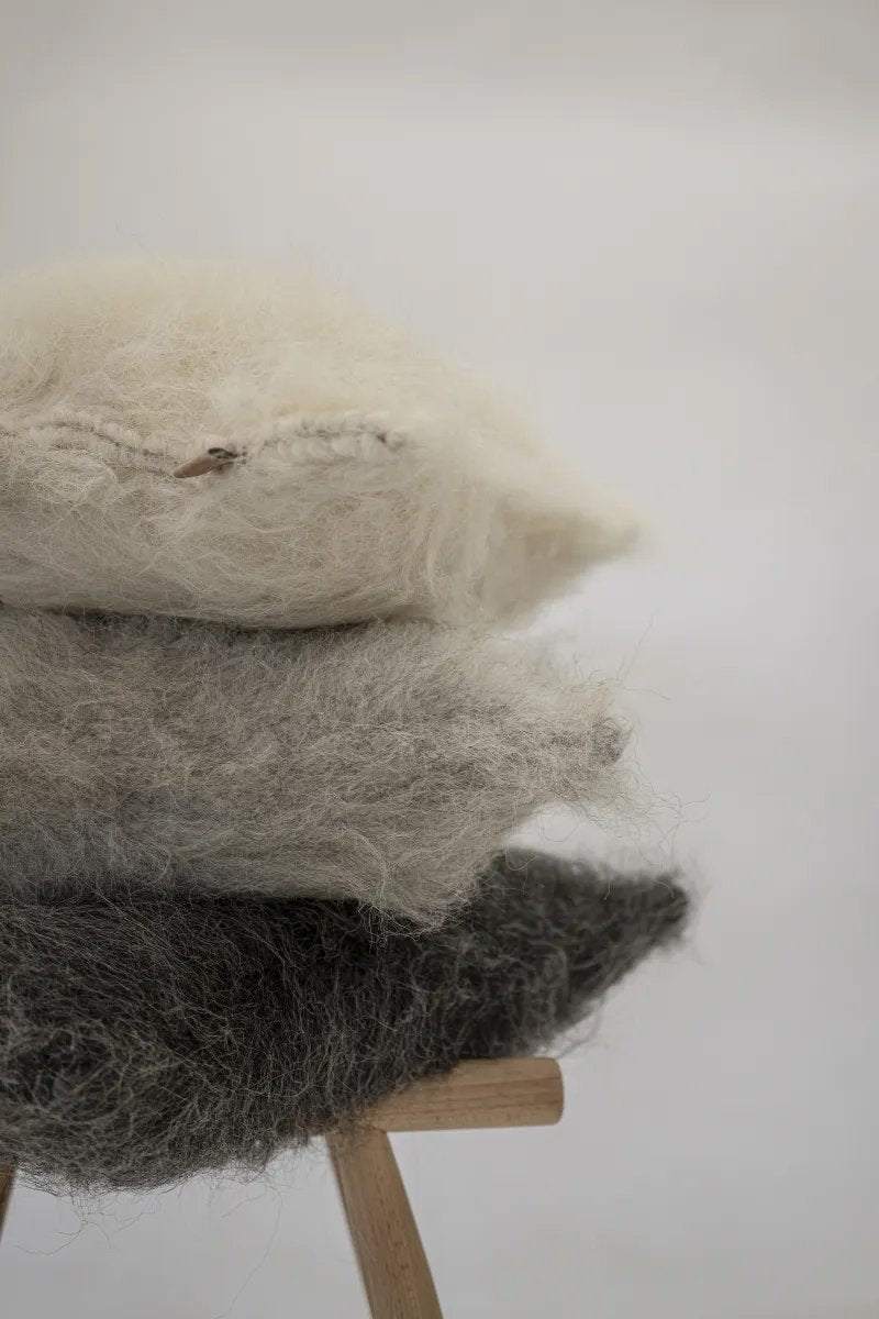 Handwoven organic wool pillow with brushed texture and soft lamb wool insert