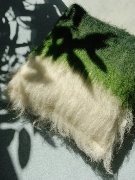 Emerald green and cream handwoven wool pillow with brushed texture and traditional craftsmanship