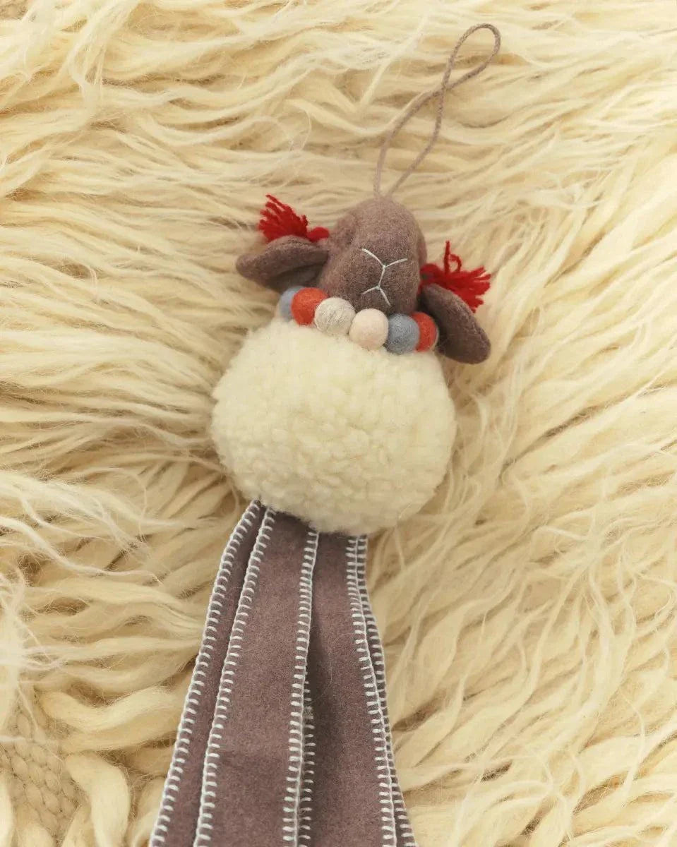 Wool Lamb Toy with a cream woolly body, brown felt face and long stitched legs, accented with red tufts and beads.