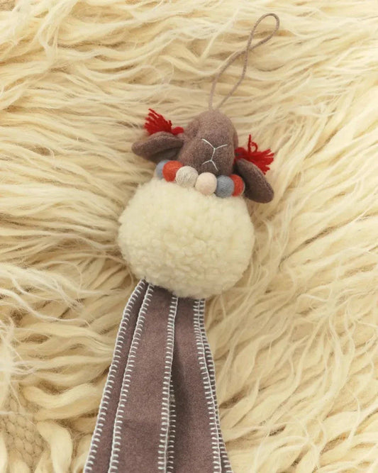 Wool Lamb Toy with a cream woolly body, brown felt face and long stitched legs, accented with red tufts and beads.