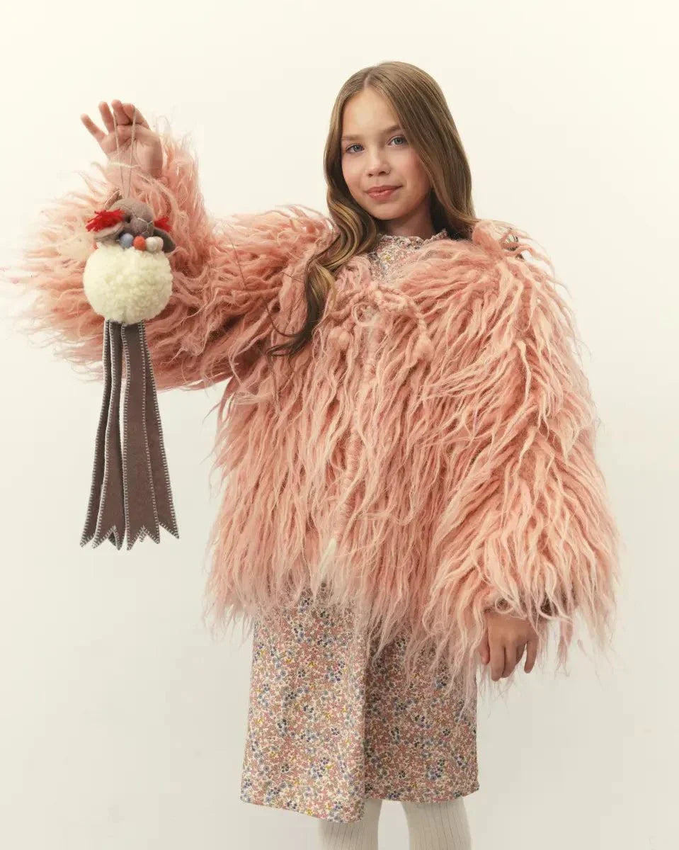 Wool Lamb Toy with a cream wool body, pink tufted head details and long brown ribbon legs for a playful look.