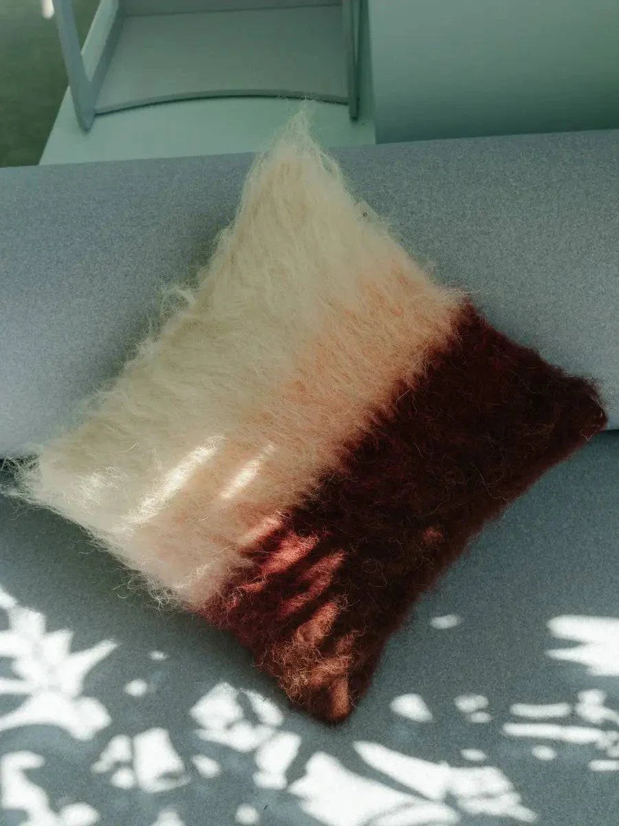 Burgundy pink and cream handwoven wool pillow with brushed texture on a cotton base