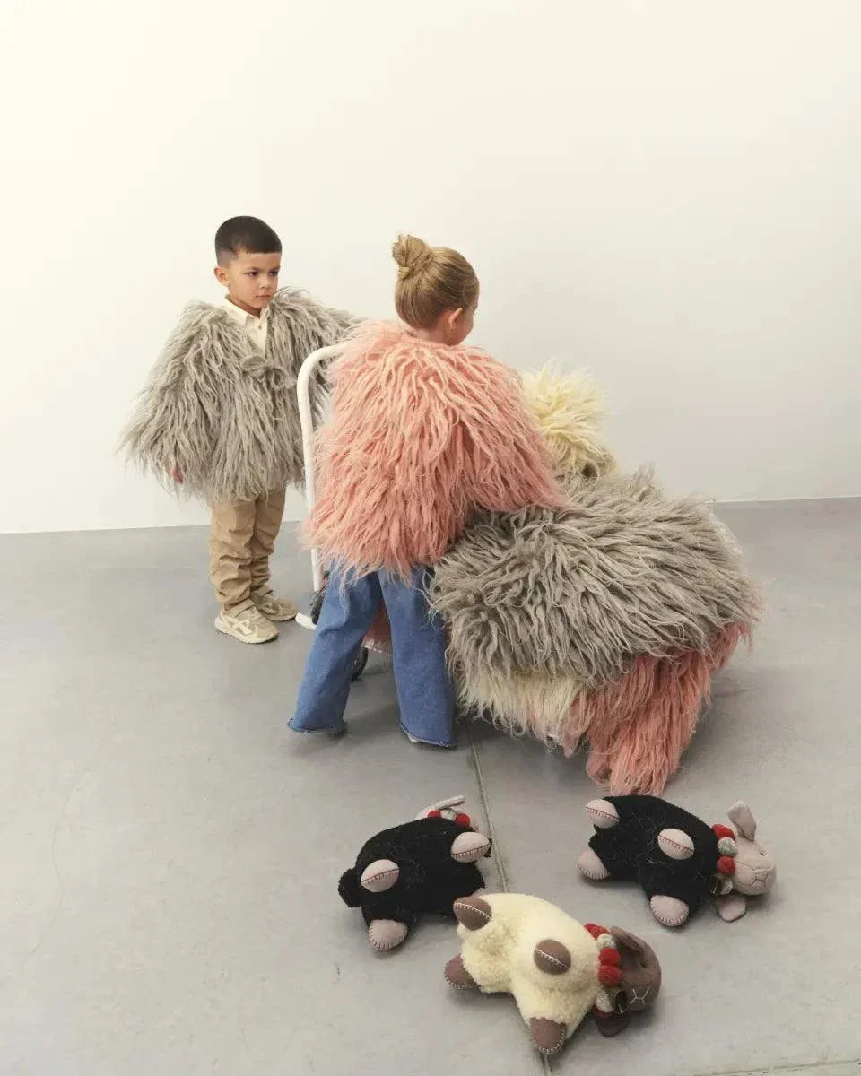 Wool Lamb Toy with long shaggy gray and pink wool fleece, beige face and dark brown ears, shown in oversized scale.