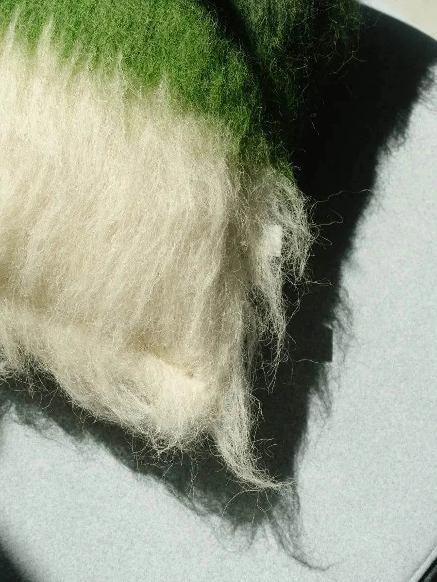 Emerald green and cream handwoven wool pillow with brushed texture and traditional craftsmanship