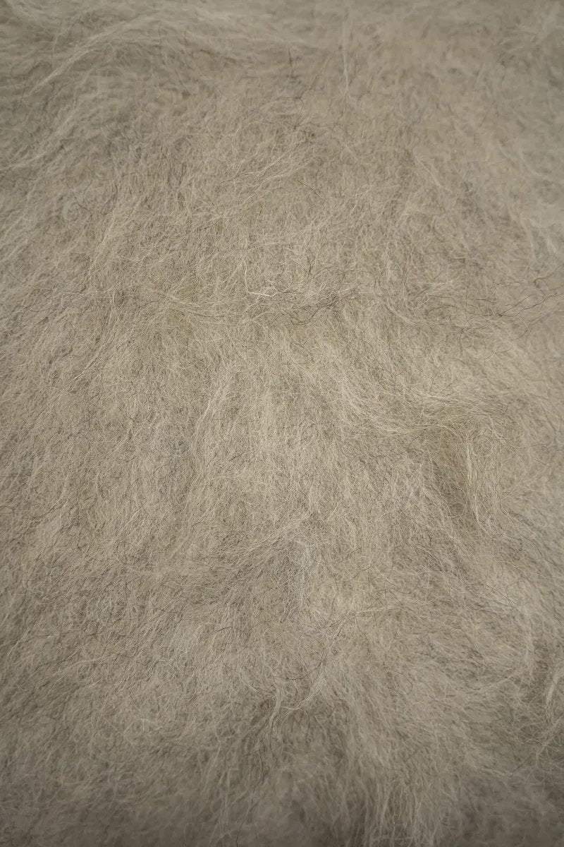 Handwoven organic wool pillow with soft brushed texture and decorative design