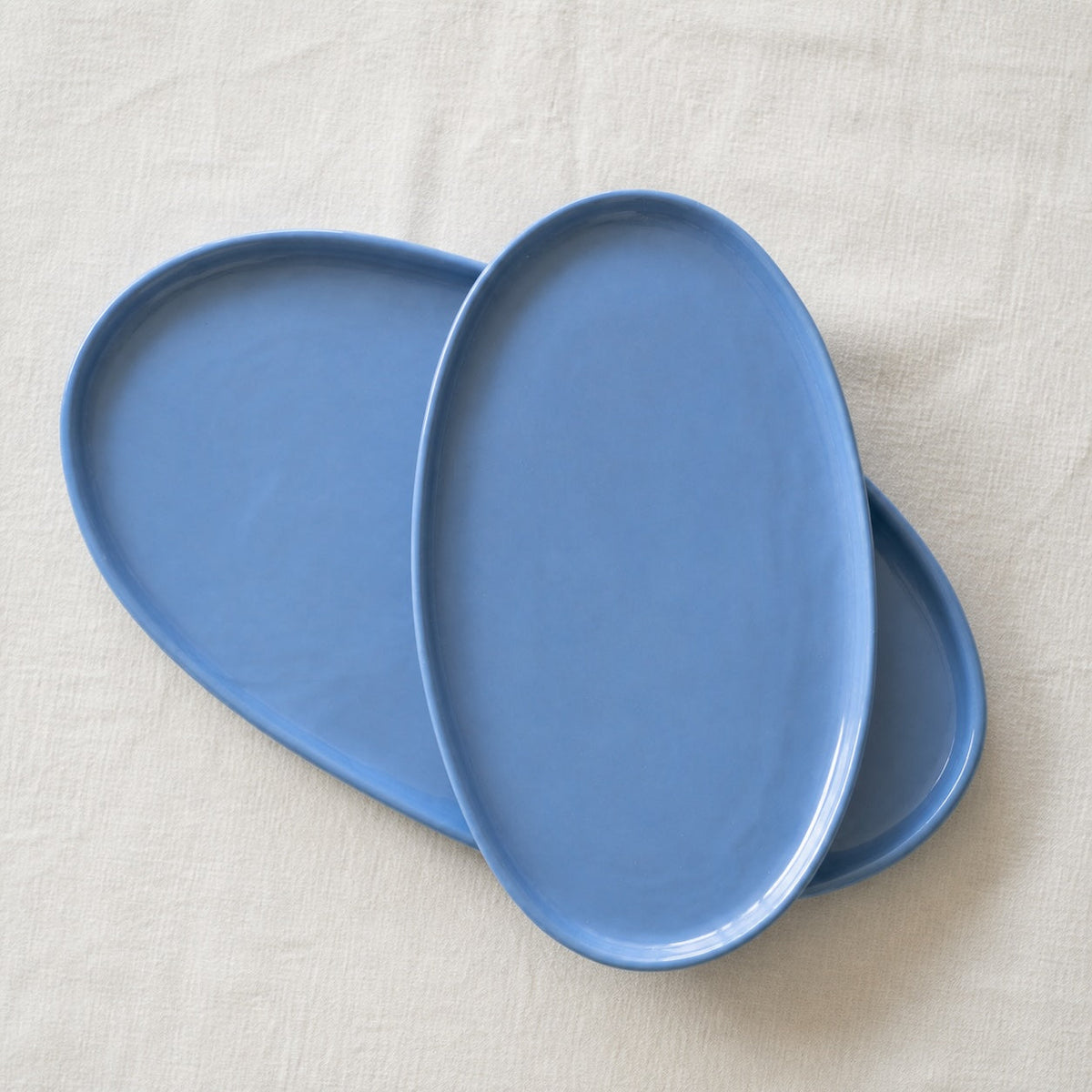 Oval Serving Platter in blue glazed porcelain, with a smooth finish, raised rim, and organic rounded edges.