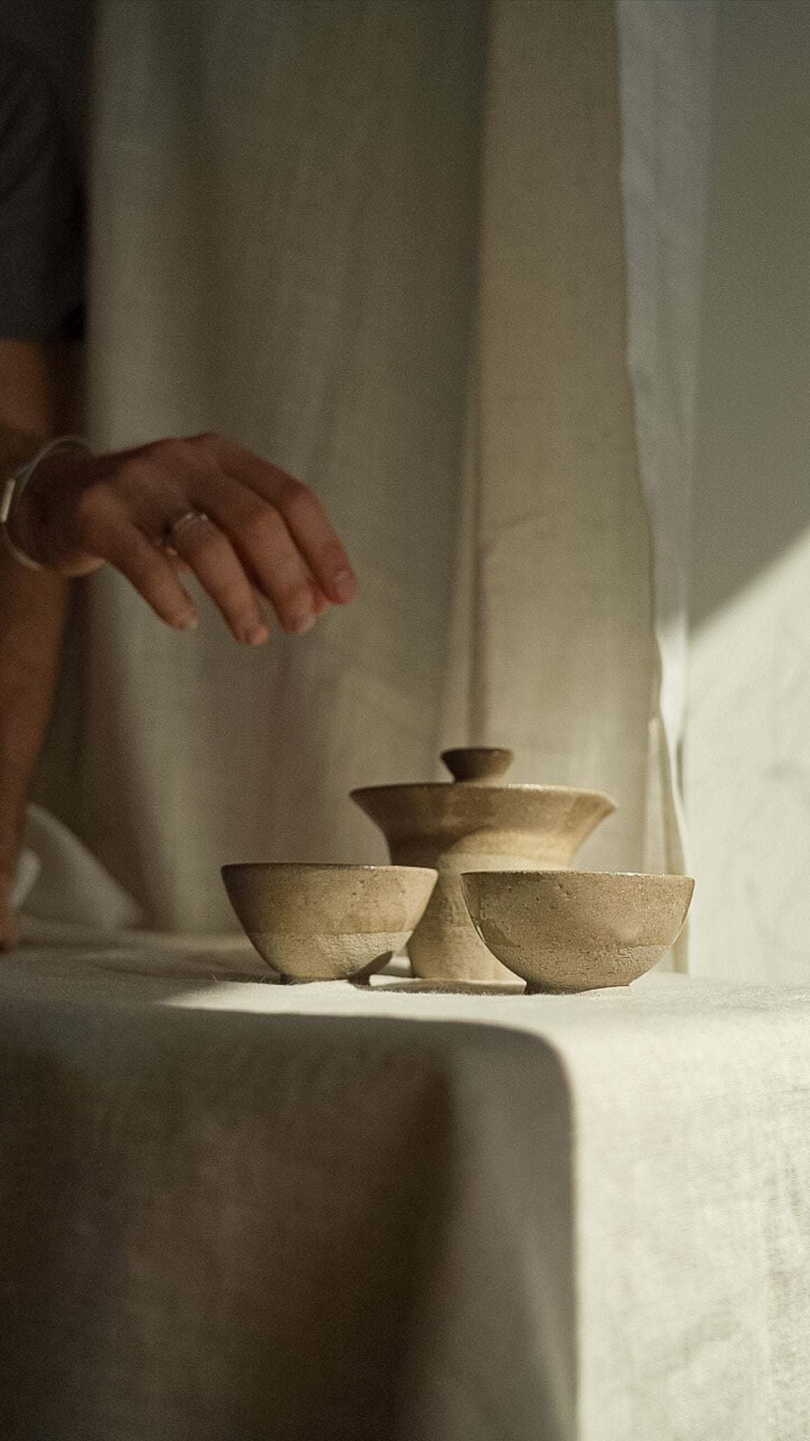 Handmade Stoneware Small Tea Cup in warm gray with a subtle speckled finish and a simple rounded shape.