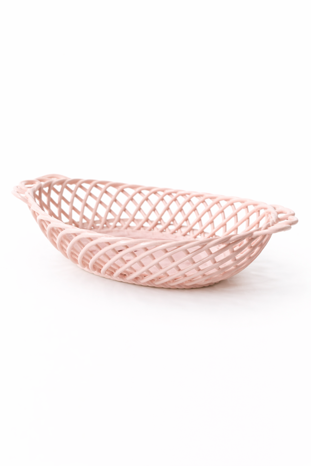 Ceramic Oval Basket in glossy pale pink porcelain, with an oval shape and airy interwoven lattice design.
