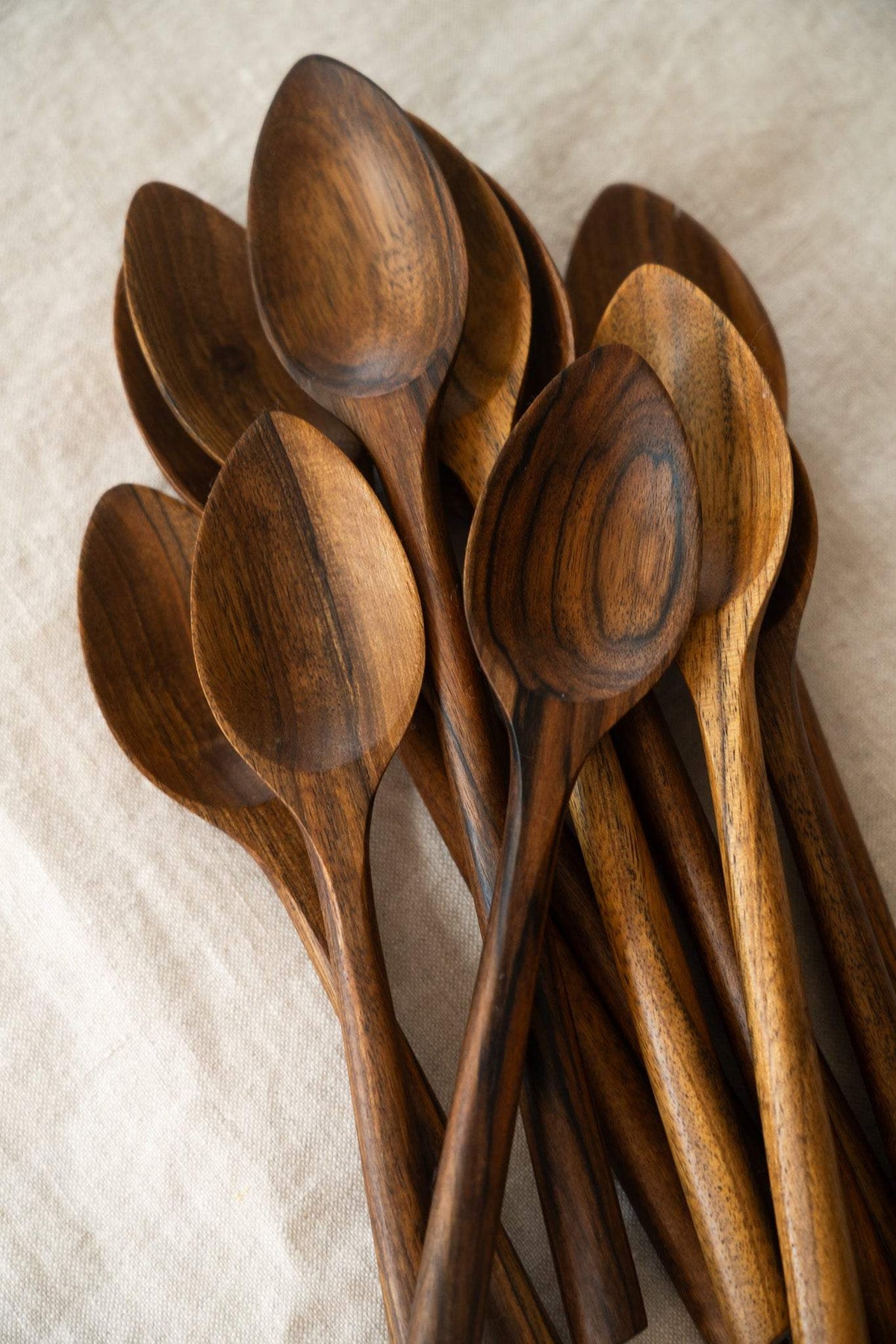 Soup Walnut Wood Spoon with a deep oval bowl, warm brown hand-carved wood and distinctive dark grain patterns.