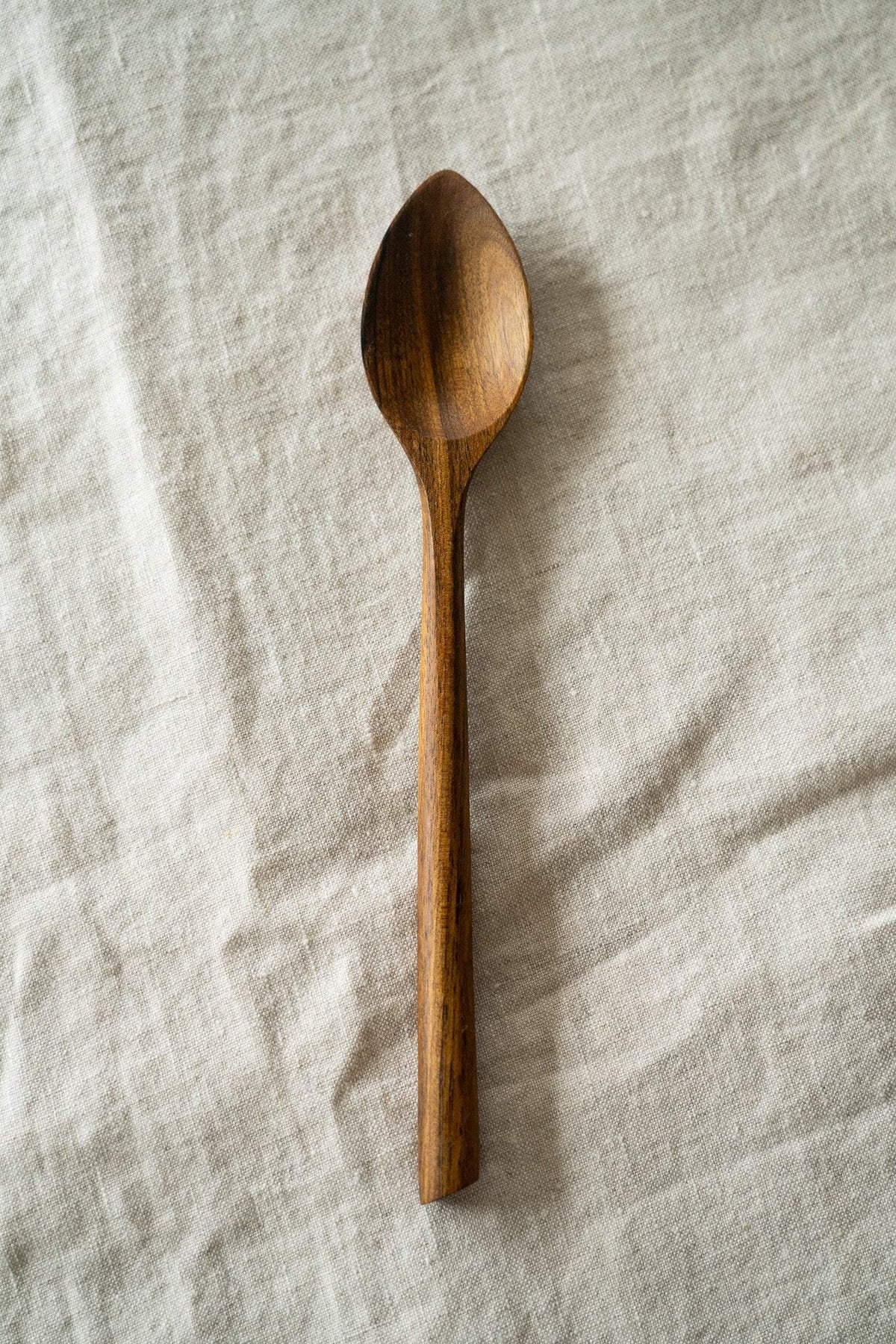 Soup Walnut Wood Spoon in warm brown natural walnut, with distinctive dark grain and a deep, smoothly carved bowl.