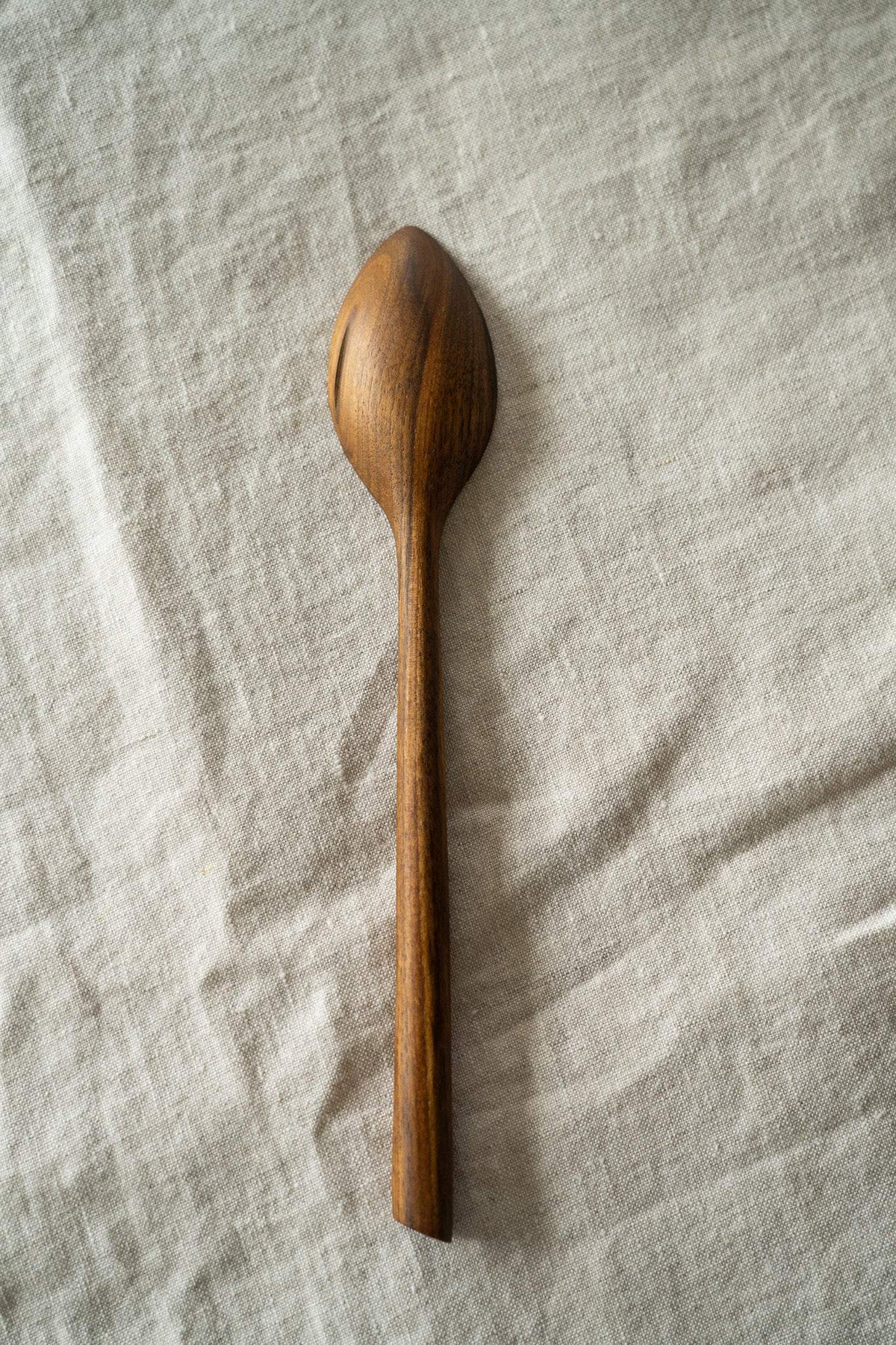 Soup Walnut Wood Spoon in warm brown walnut, hand-carved with rich natural grain and a long, slender handle.
