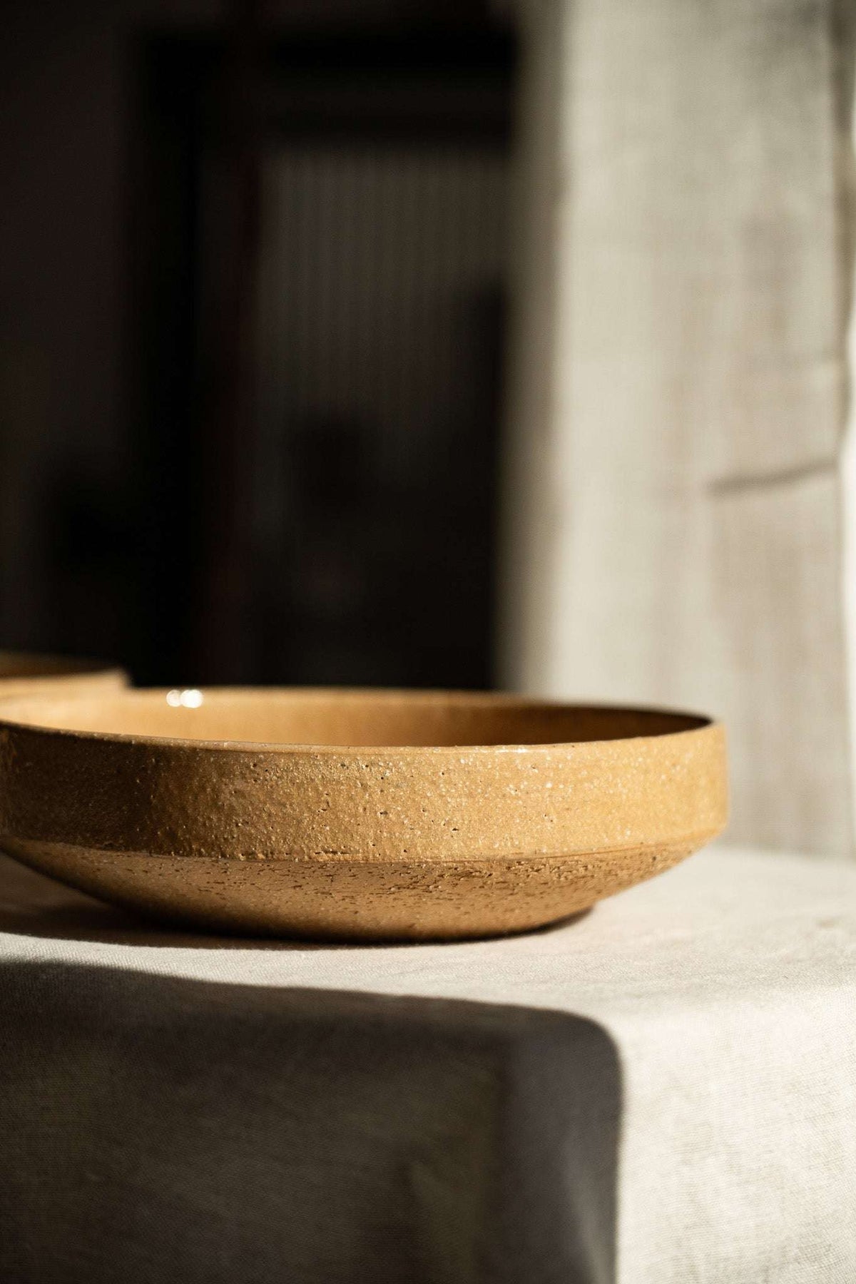 Handmade stoneware breakfast bowl in yellow clay with natural speckles and glazed interior