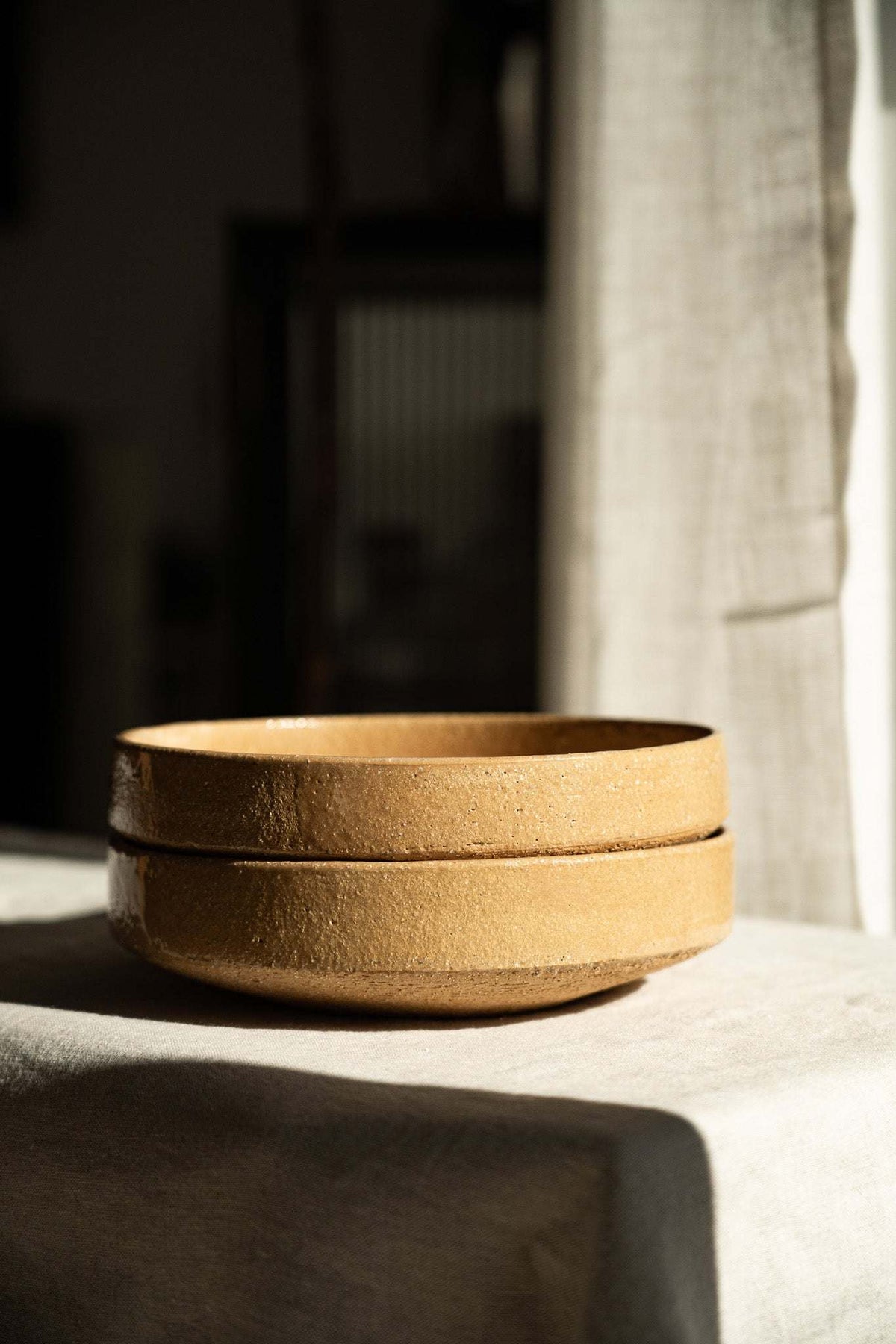 Handmade stoneware breakfast bowl in yellow clay with natural speckles and glazed interior