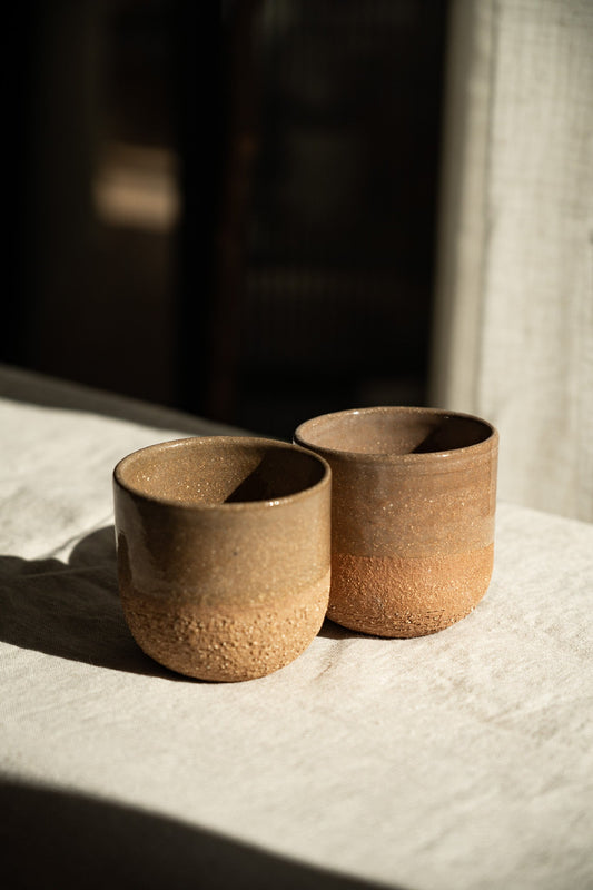 Handmade Pottery Coffee Cup in warm speckled brown stoneware, with a glossy finish and rounded, handleless shape.