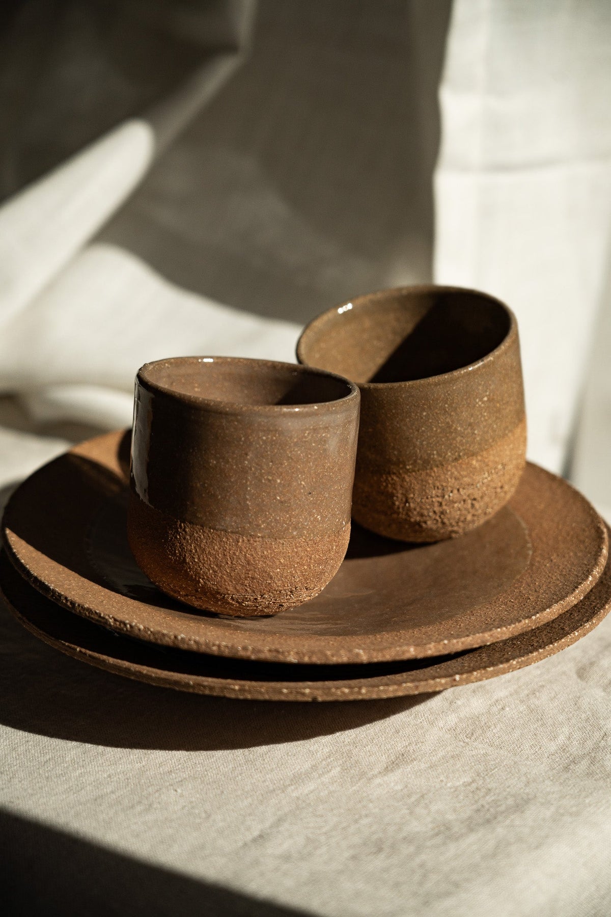 Handmade Pottery Coffee Cup in warm brown stoneware, with a speckled matte finish, rounded shape, and no visible handle.