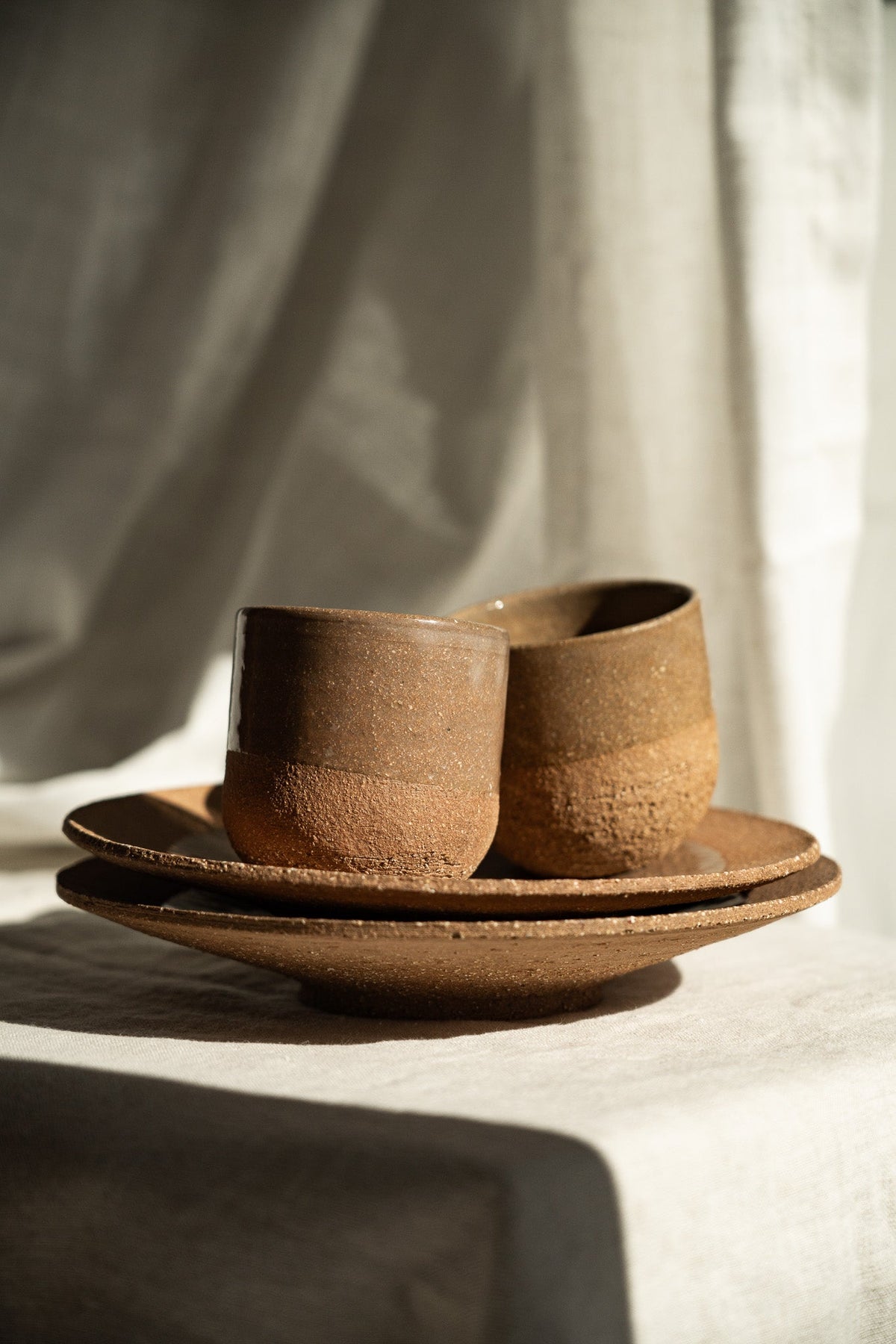 Handmade Pottery Coffee Cup in warm brown stoneware, with a speckled matte finish, rounded form and subtle handmade variations.