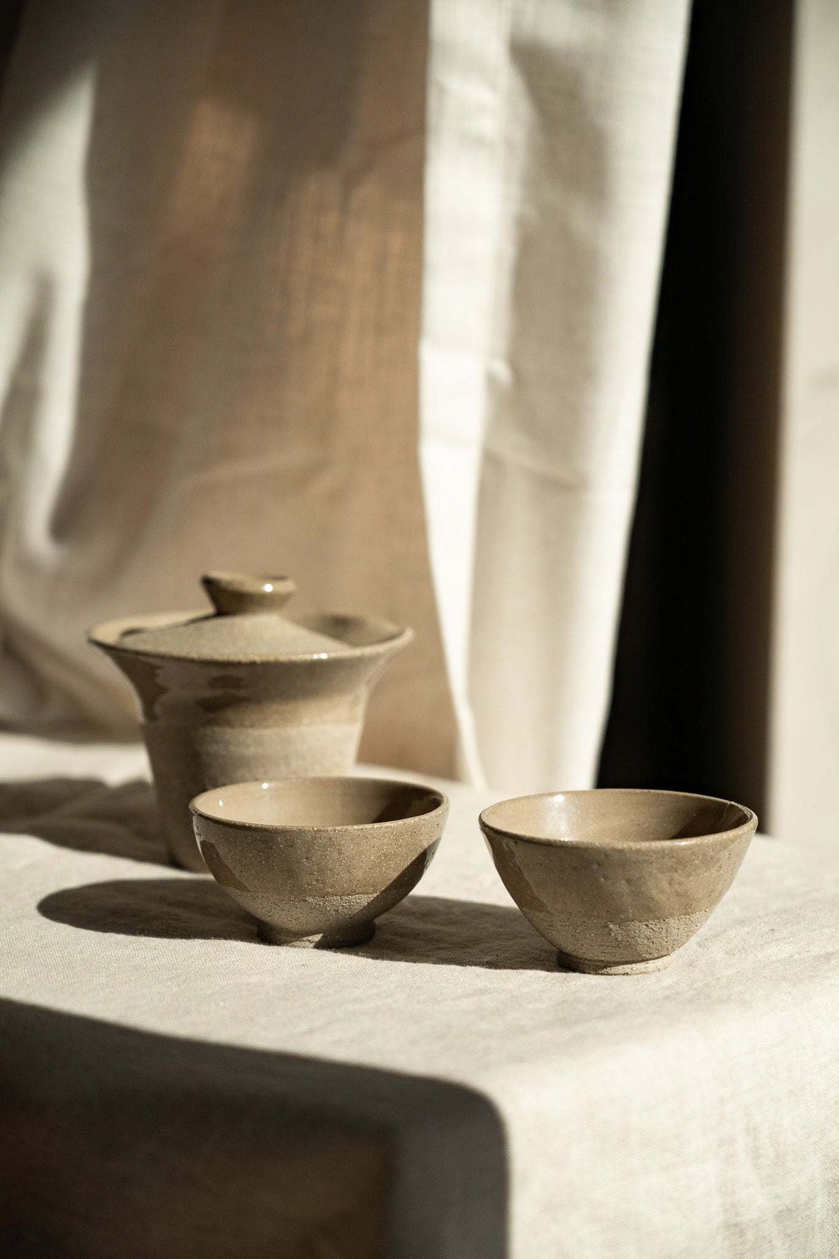 Handmade Stoneware Small Tea Cup set in muted gray-beige, with a speckled matte finish and gently rounded shape.