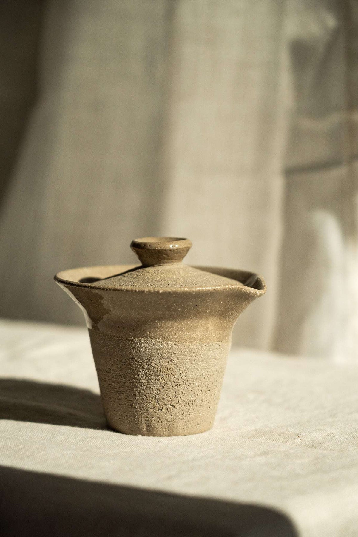 Handmade Stoneware Gaiwan in sandy gray stoneware with fine speckles, a fitted lid, and gently flared rim.