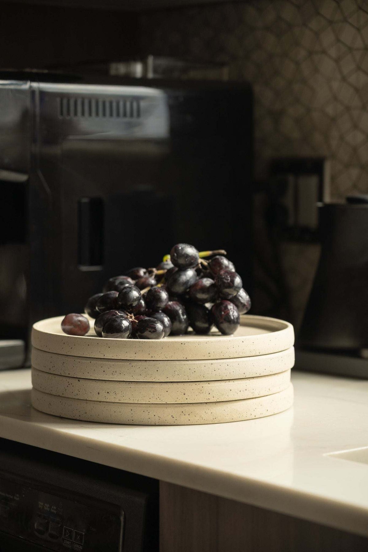 Stoneware Pottery Plate in cream stoneware with fine brown speckles, handmade with a smooth raised rim.