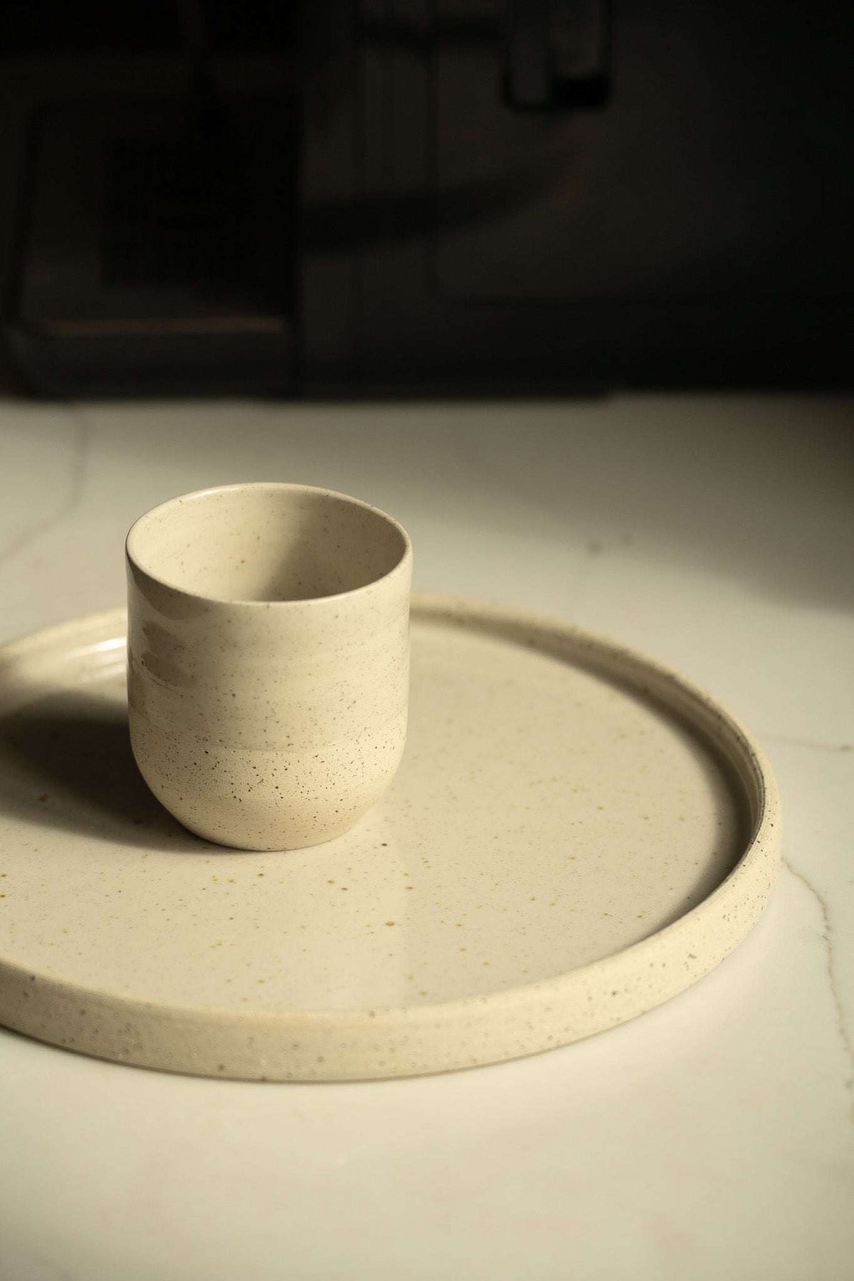 Small Coffee Cup in cream-white speckled stoneware, with a simple rounded shape and matte rustic finish.