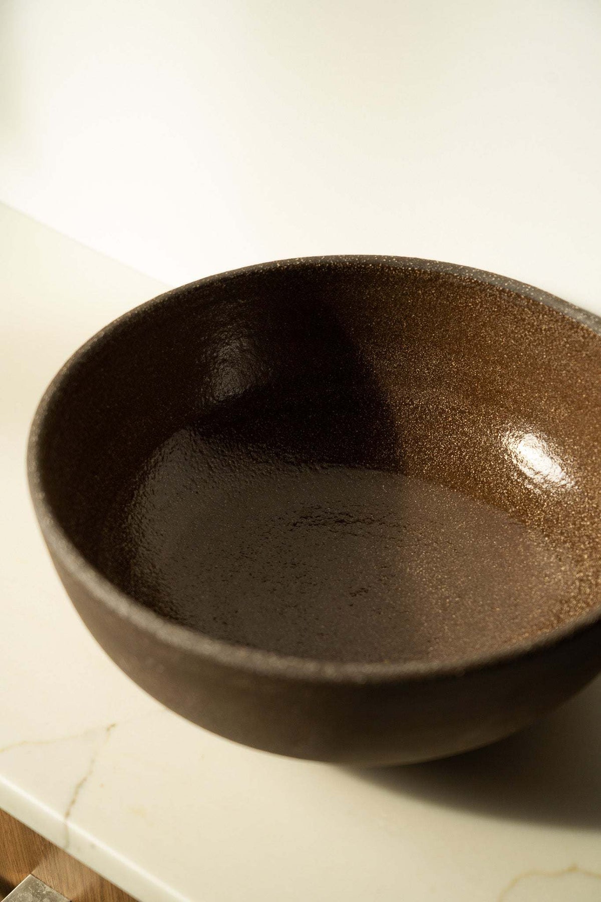 Stoneware Large Fruit Bowl in dark brown speckled glaze, with a broad rounded shape and smooth interior surface.