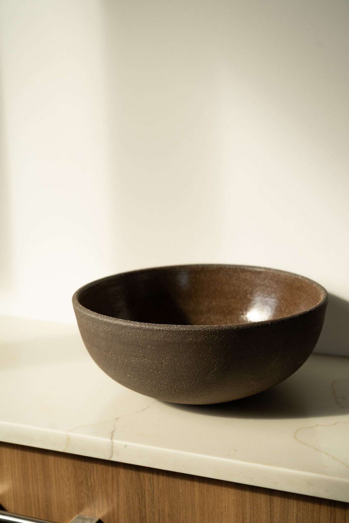 Stoneware Large Fruit Bowl in dark brown with a smooth glazed interior and subtly textured exterior.