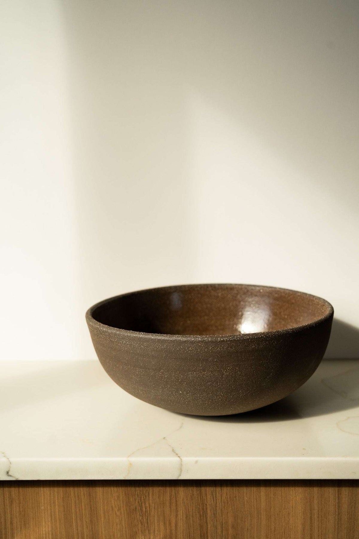 Stoneware Large Fruit Bowl in deep brown, with a subtly speckled matte exterior and smooth glazed interior.