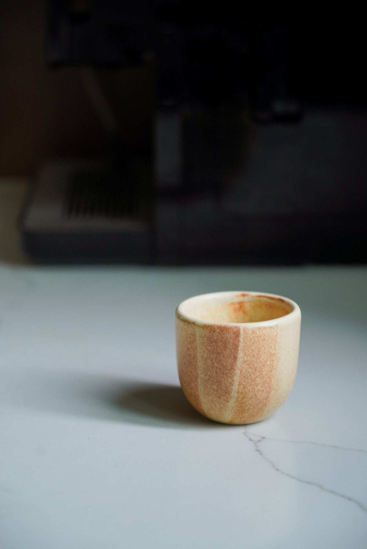 Beige stoneware espresso coffee cup with organic edges and reactive glaze, handmade in Ukraine