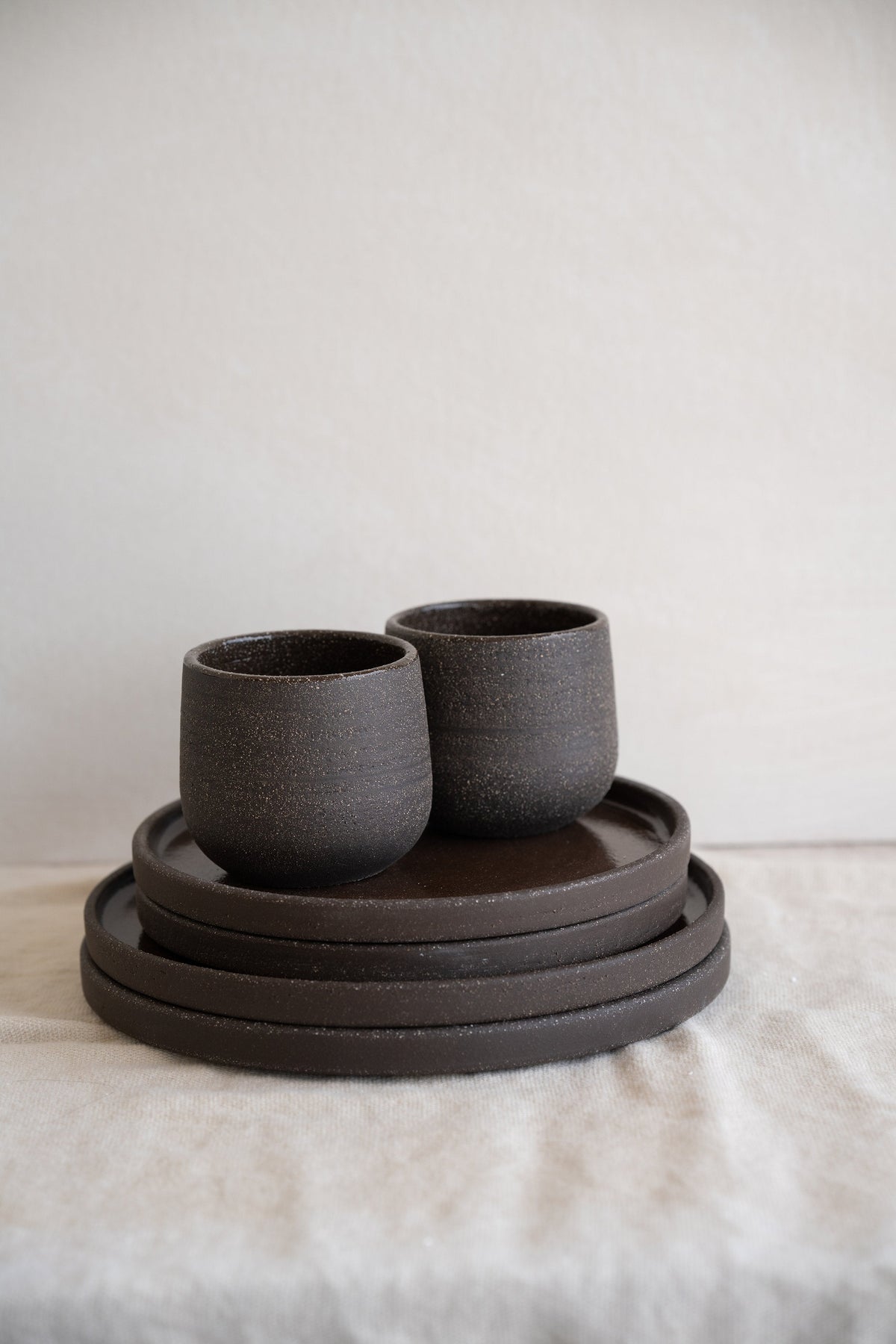 Handmade stoneware coffee cup in pumpernickel color with glazed interior and durable exterior