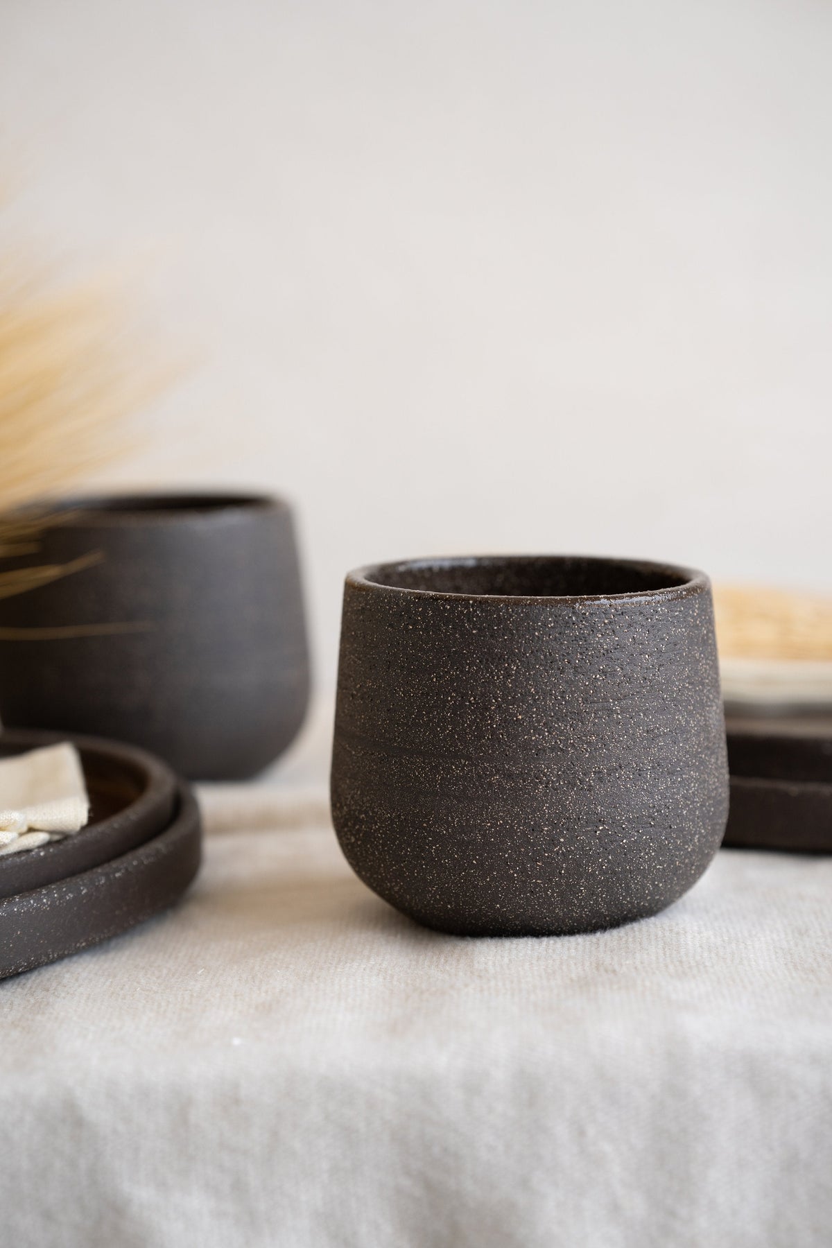 Handmade stoneware coffee cup in pumpernickel color with glazed interior, durable and dishwasher safe
