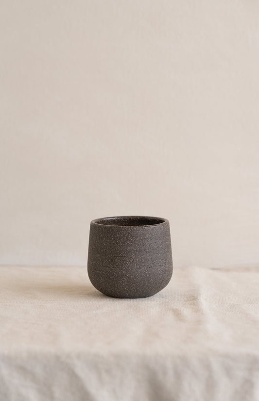 Handmade stoneware coffee cup in pumpernickel color with glazed interior, durable and food-safe