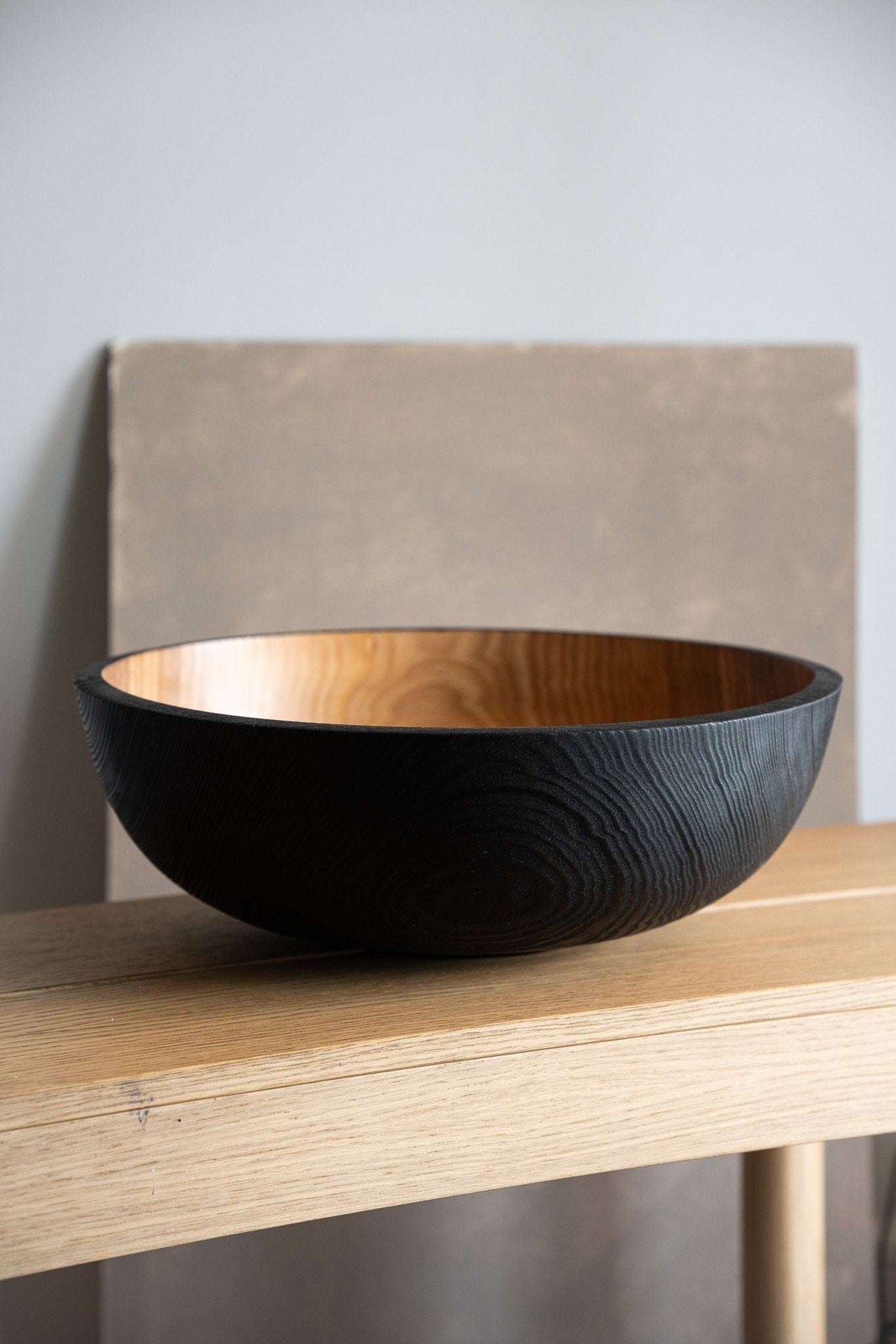 Hand carved extra large ash wood bowl with half charred black interior and food-safe finish
