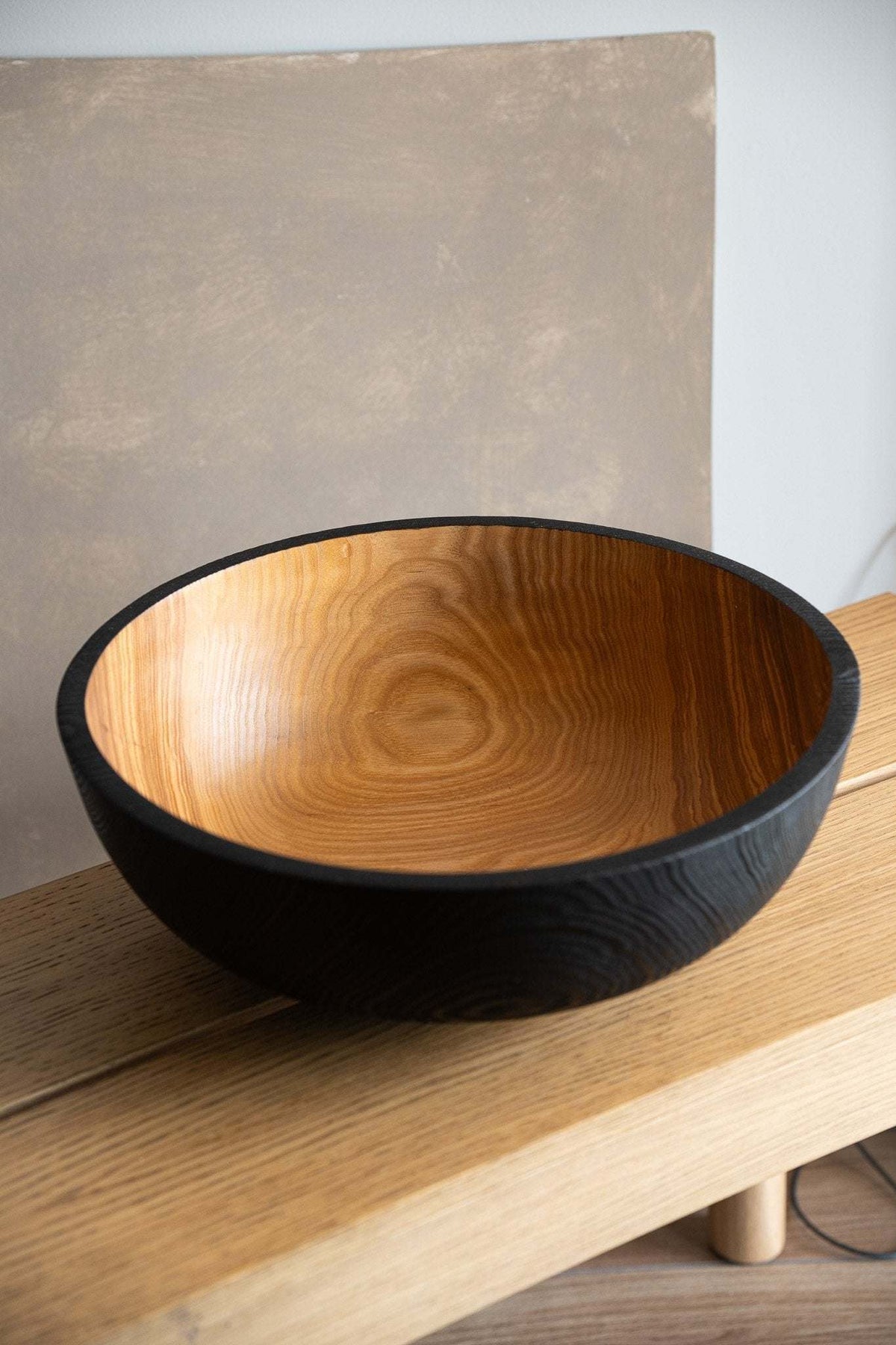 Hand carved large wooden bowl with half charred black ash wood interior and natural textured exterior