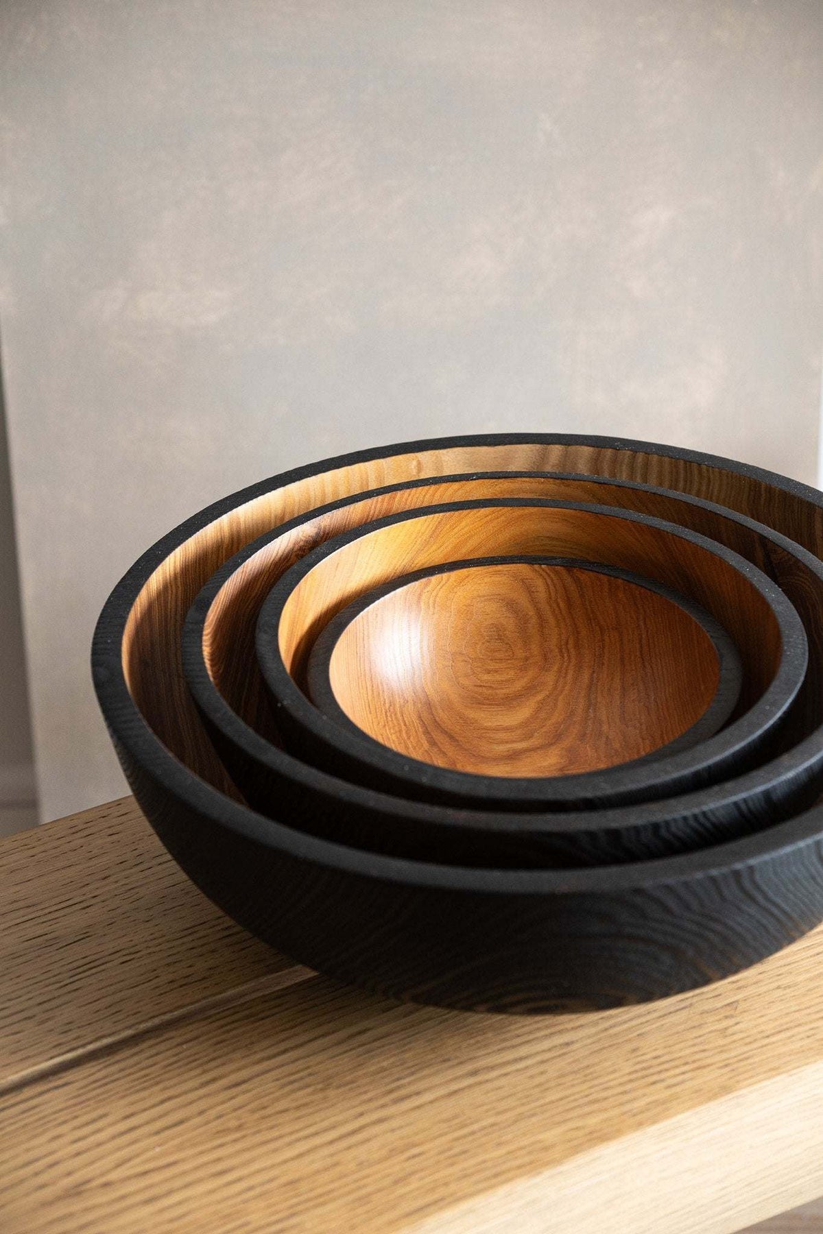 Hand carved extra large wooden bowl with half charred interior and solid ash wood exterior