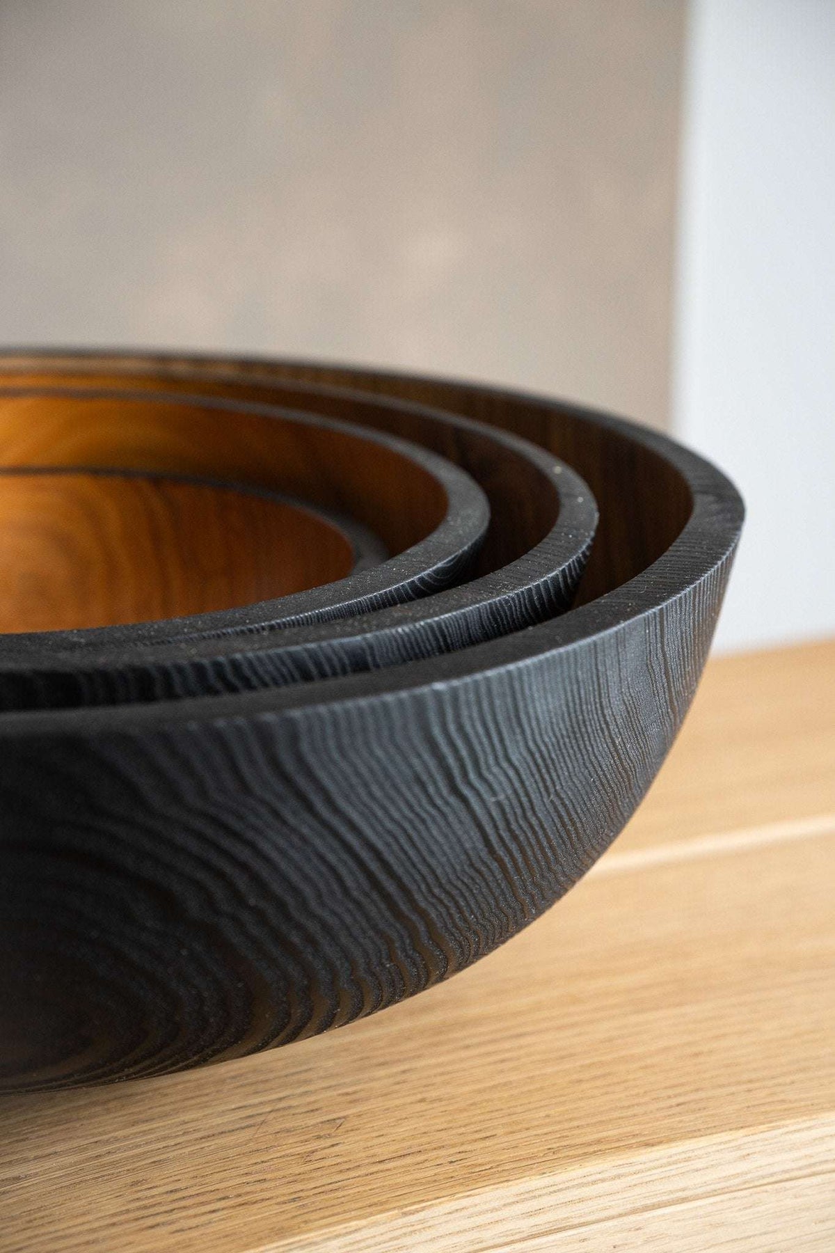 Hand carved extra large wooden bowl with half charred interior made from solid ash wood for serving salads and fruits