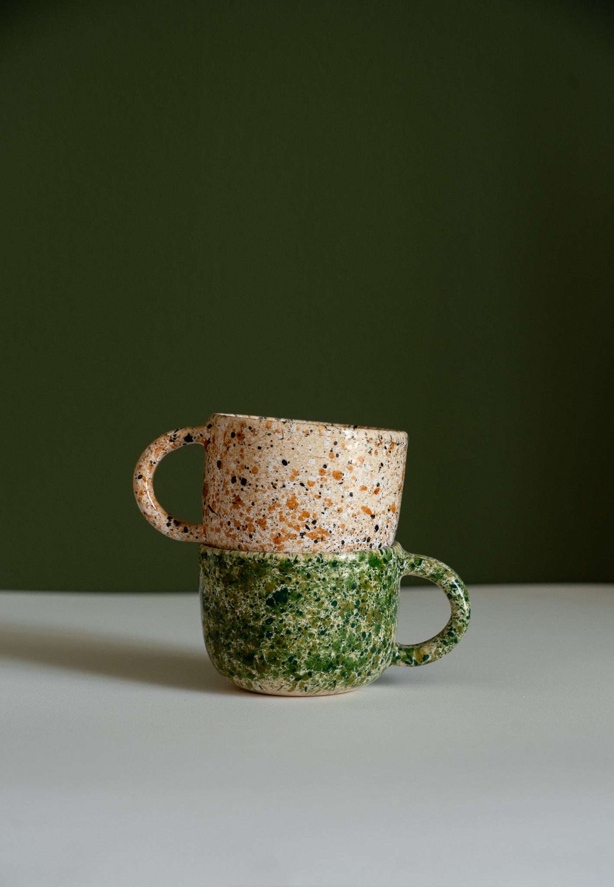 Hand painted personalized stoneware mug with double handle and splatter glaze design