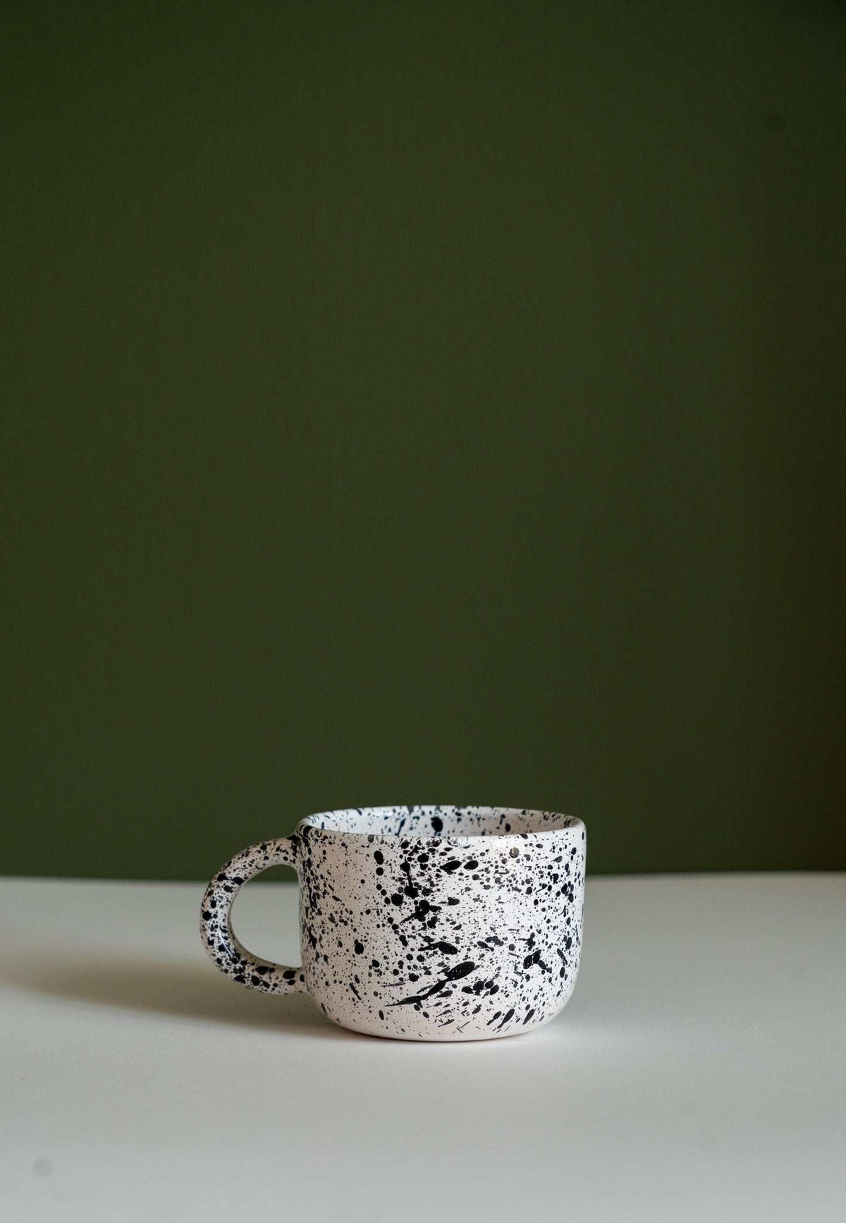 Hand painted personalized stoneware mug with double handle and splatter glaze design