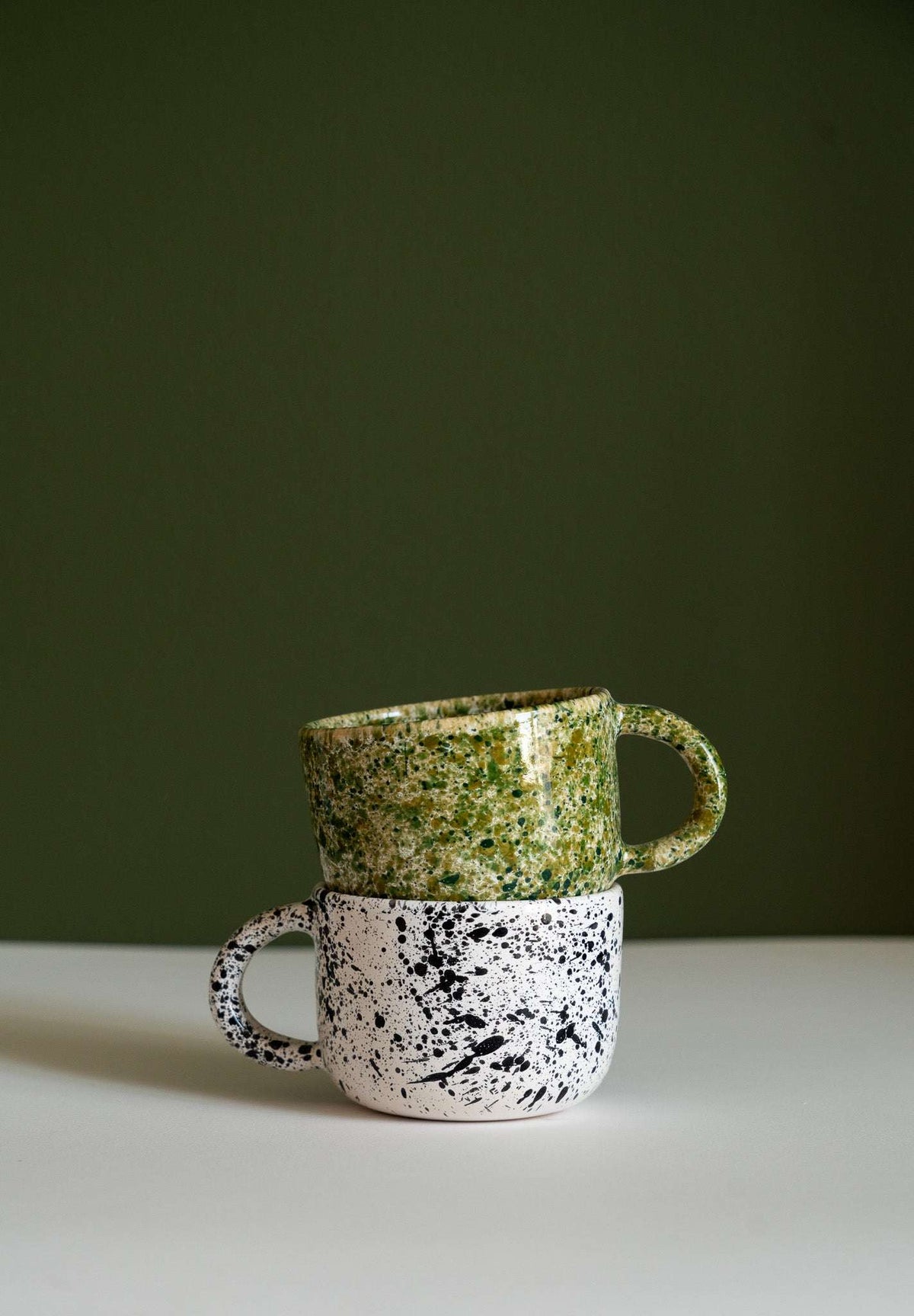 Hand painted personalized stoneware mug with double handle and splatter glaze design