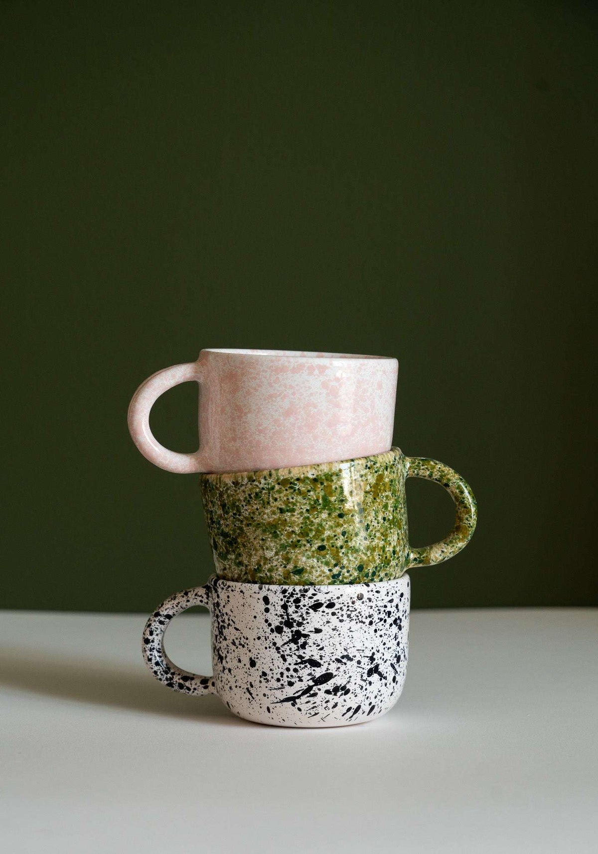 Hand painted personalized stoneware mug with double handle and splatter glaze design