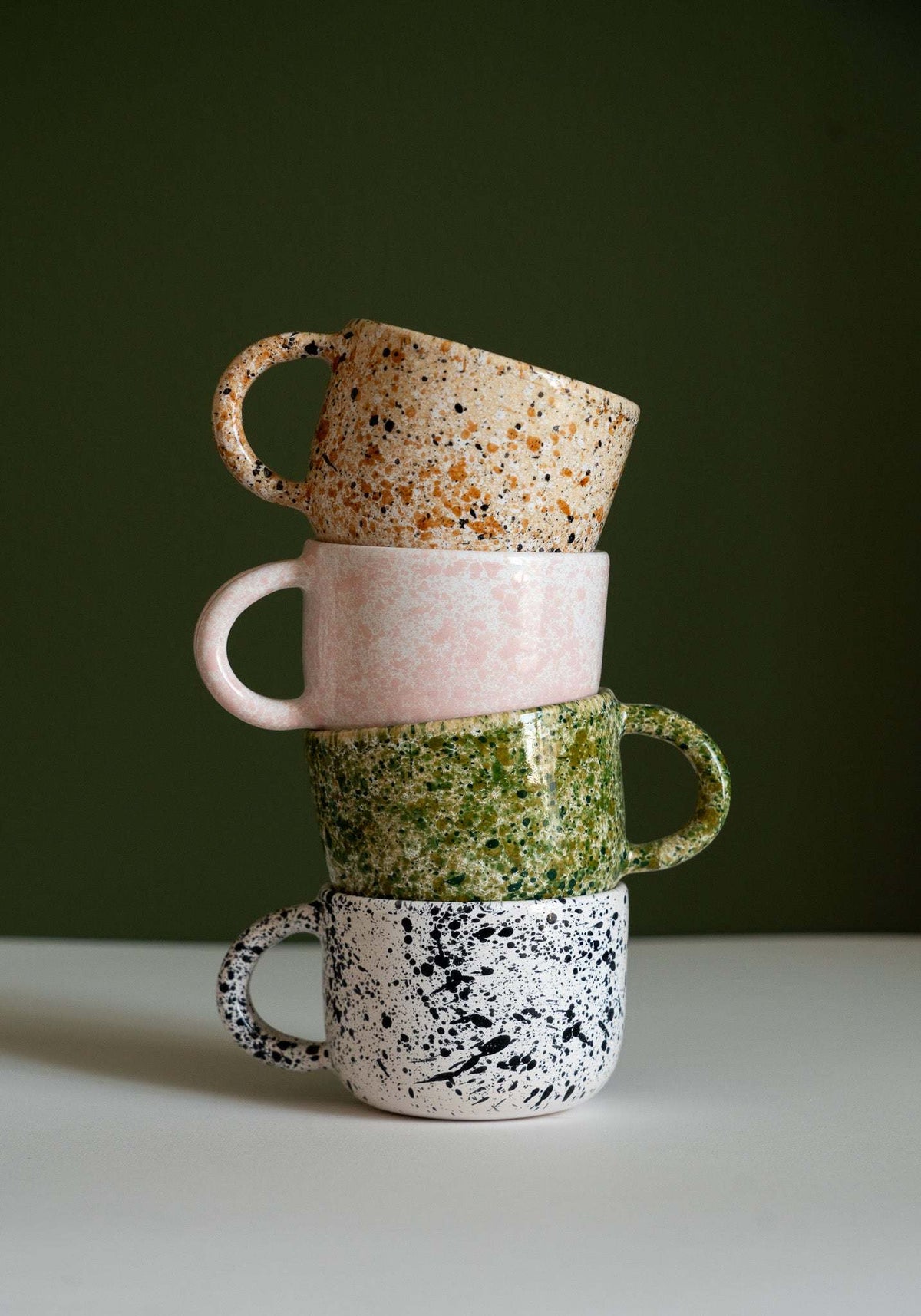 Hand painted splatter personalized stoneware mug with double handle in speckled ceramic design