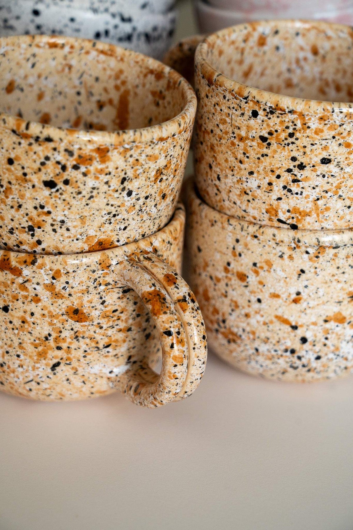 Hand painted personalized stoneware mug with double handle and splatter glaze design