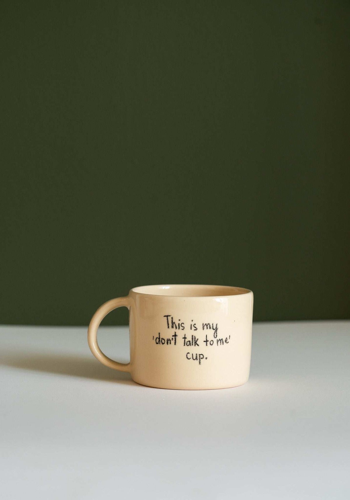 Personalized Stoneware Mug in glossy beige ceramic, with a rounded handle and handwritten “This is my don’t talk to me cup” text.