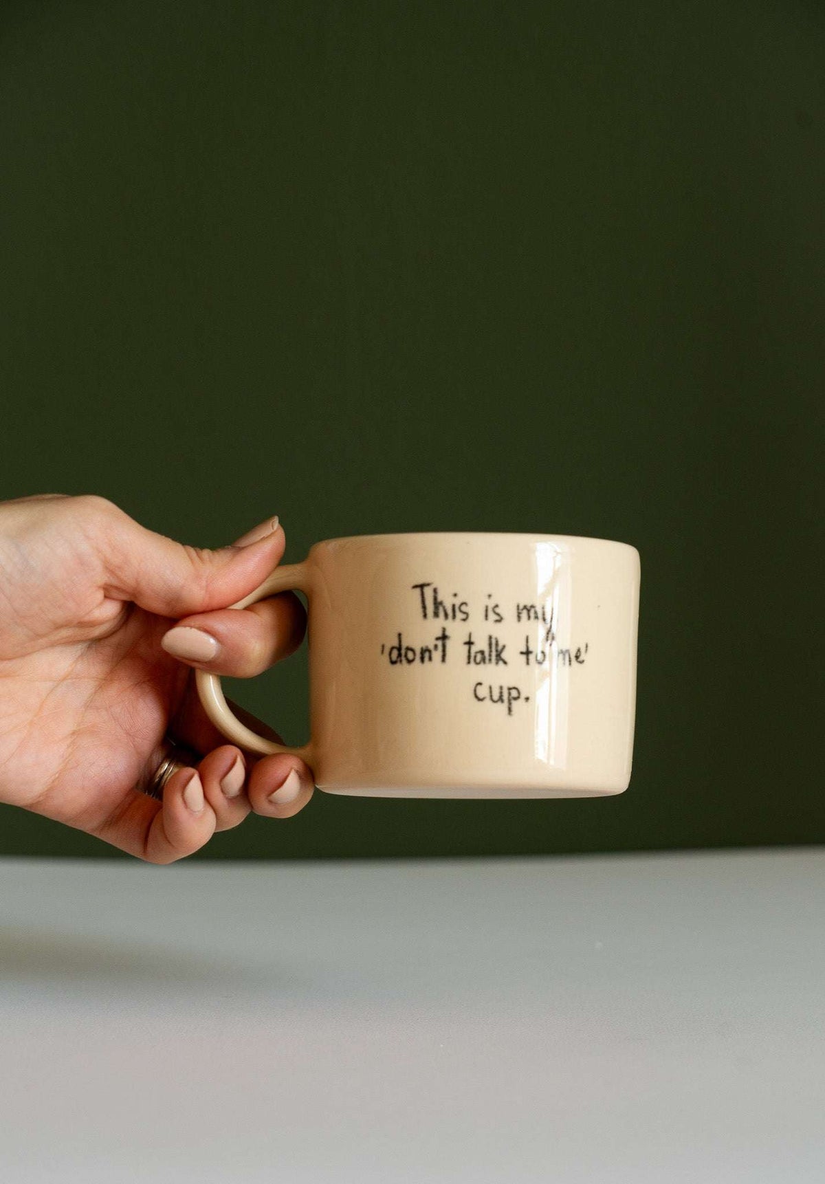 Personalized Stoneware Mug in beige glazed ceramic, with a rounded handle and handwritten “don't talk to me” message.